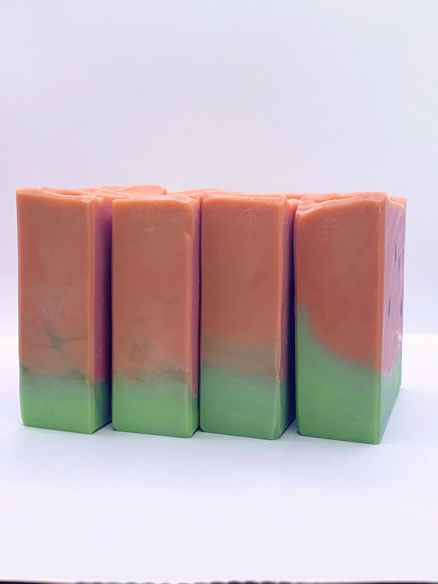 Group of handmade watermelon soaps shown from the side