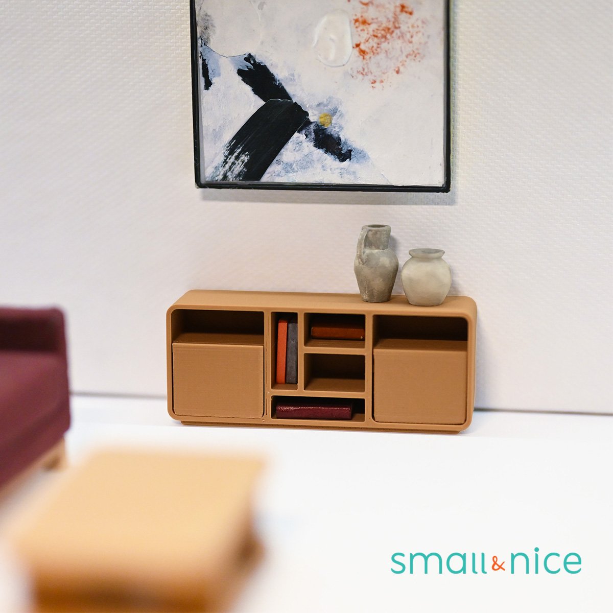 A dollhouse sized nightstand with rounded corners and one drawer