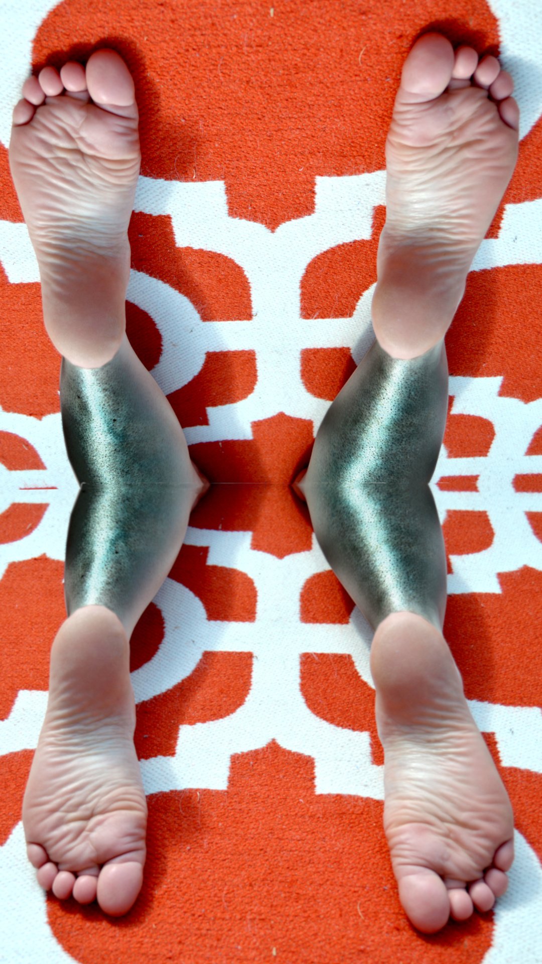 a surreal image of a woman's wrinkled soles and fish scale legs