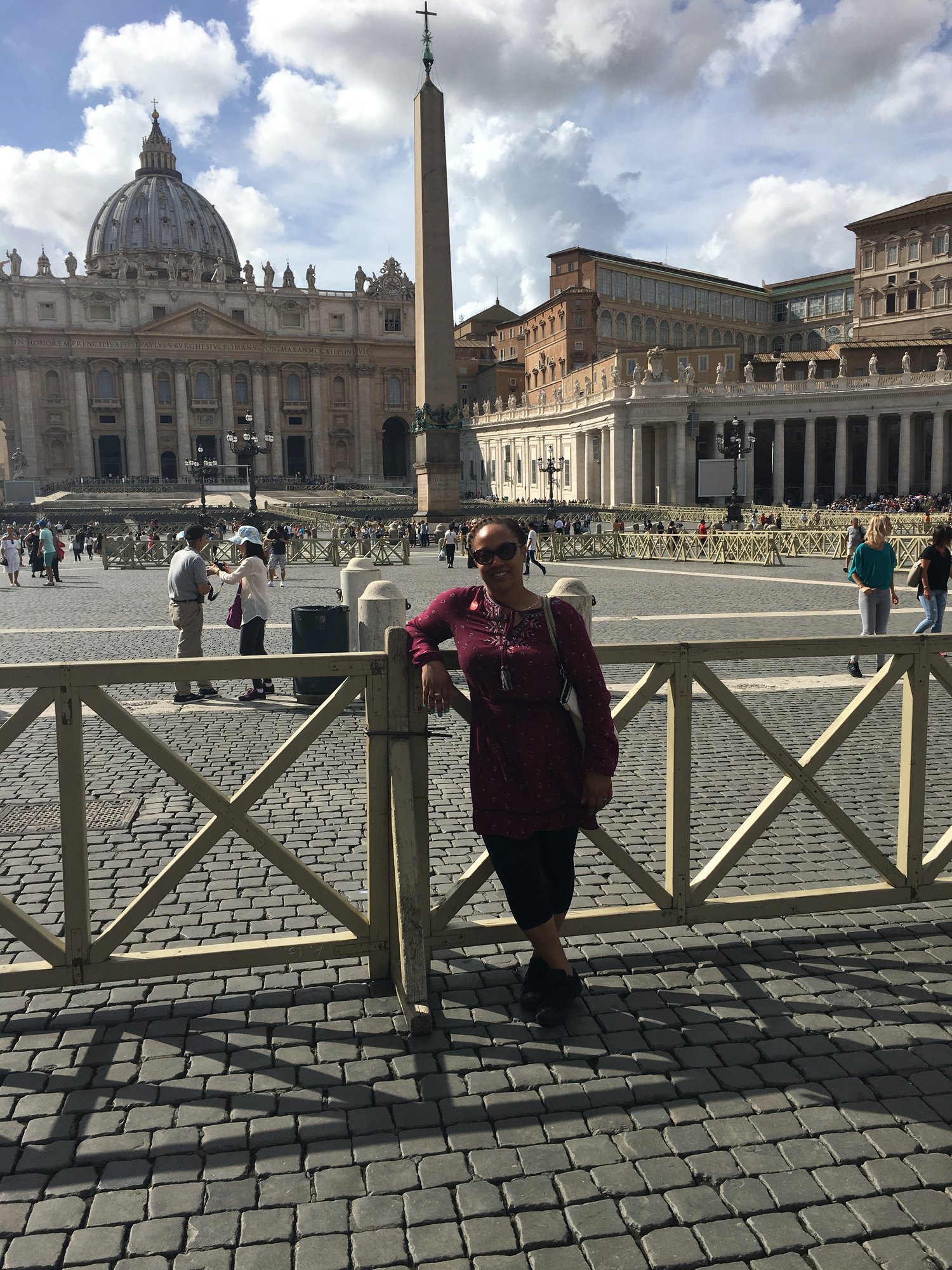 person standing with The Vatican in background