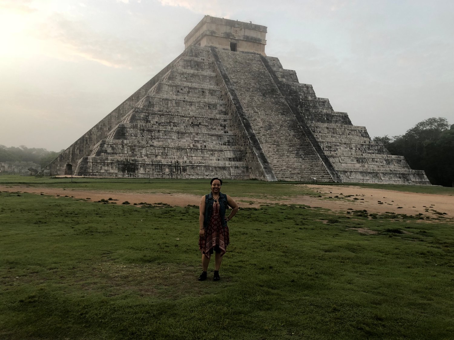 person standing in front of Mayan pyramid