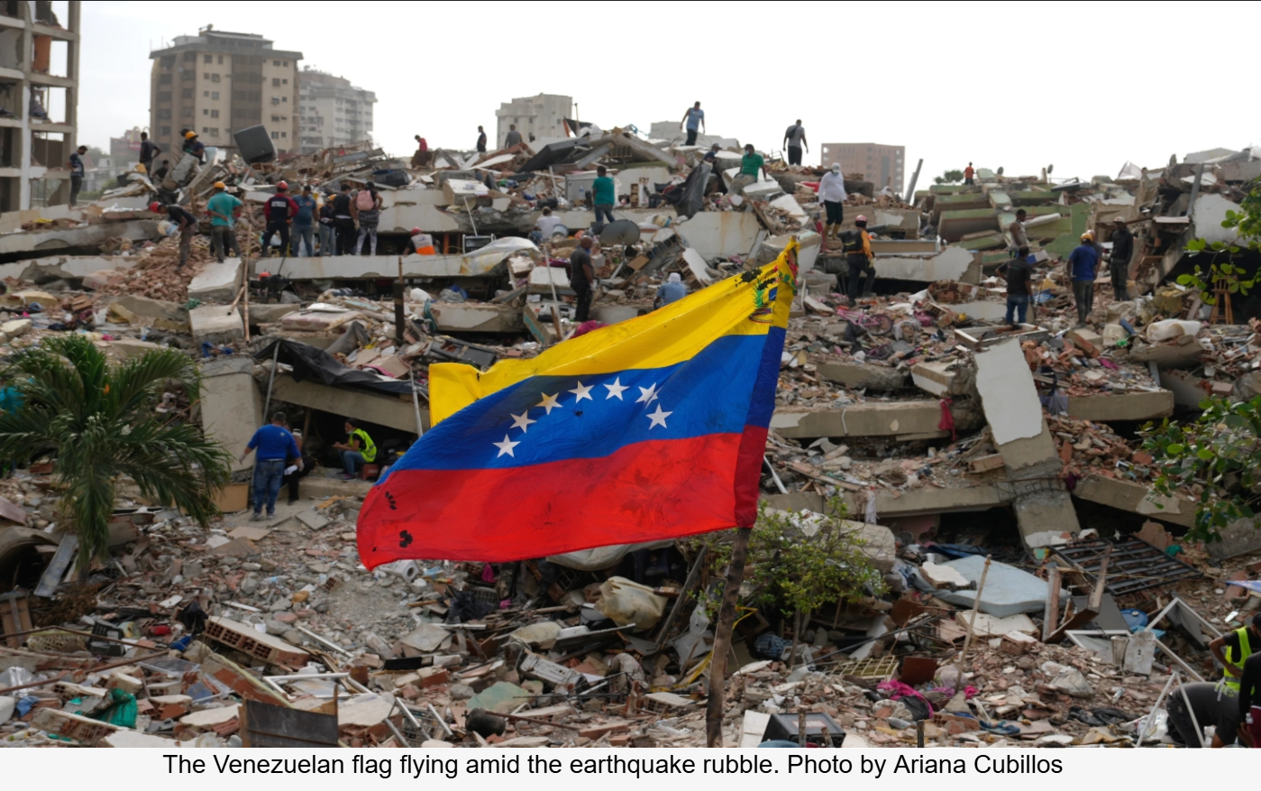 The Venezuelan flag flying amid the earthquake rubble by Ariana Cubillos