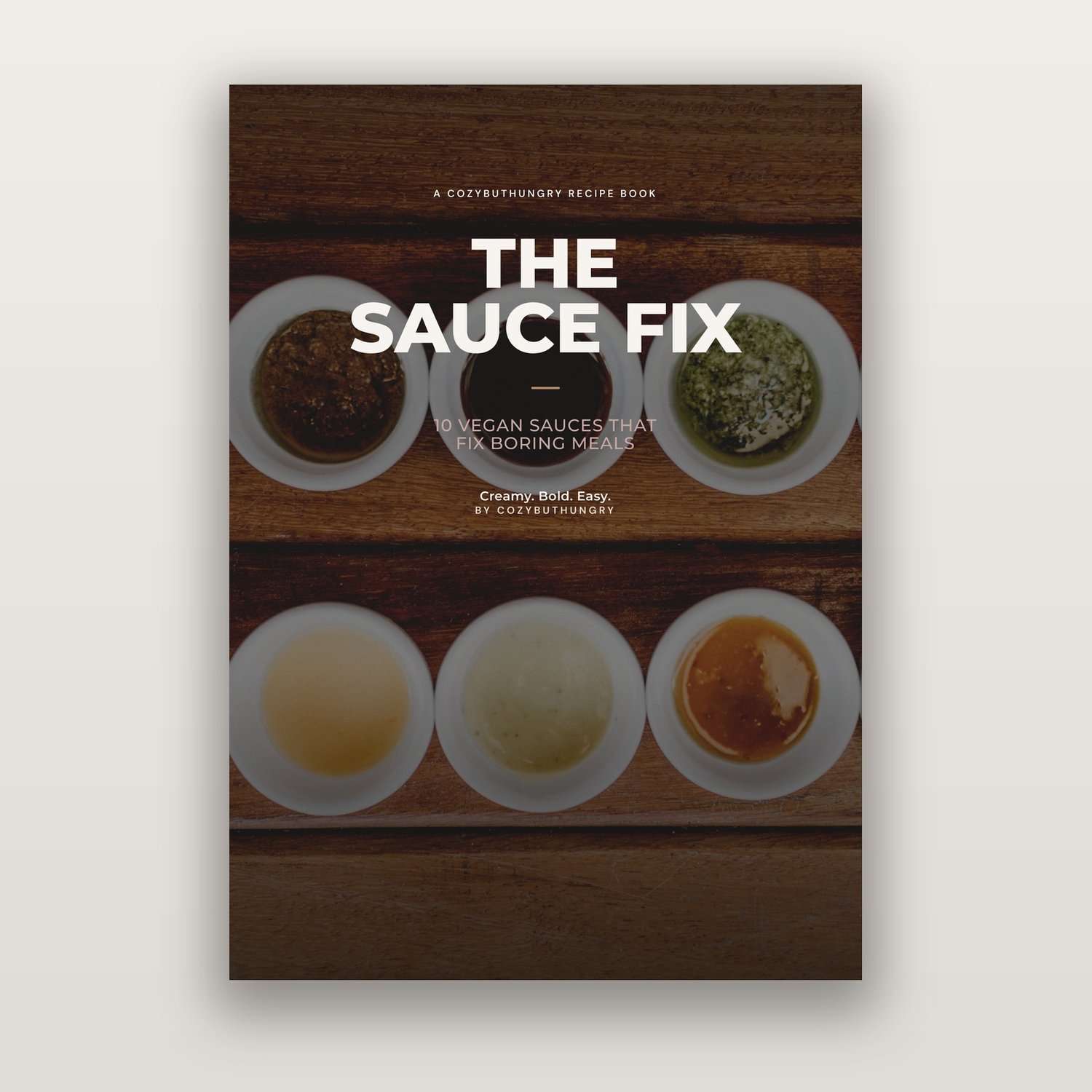 The Sauce Fix vegan sauce recipe ebook cover with a selection of creamy sauces in small bowls.