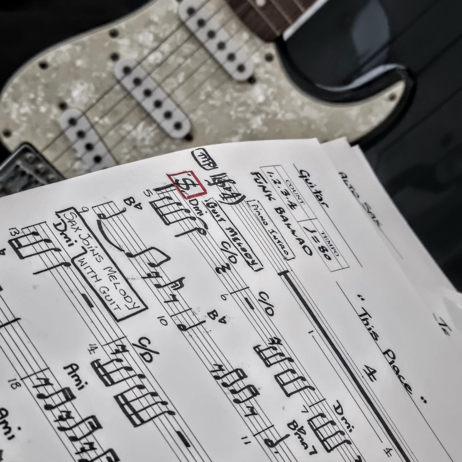Original handwritten music chart by Finnegan's Way composer Sue, with guitar in background