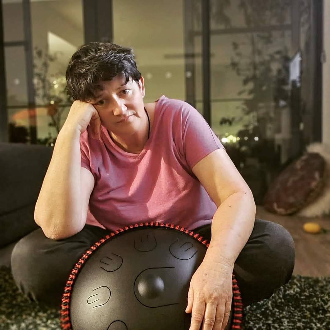 Finnegan's Way independent composer Sue with a handpan in her home music studio.