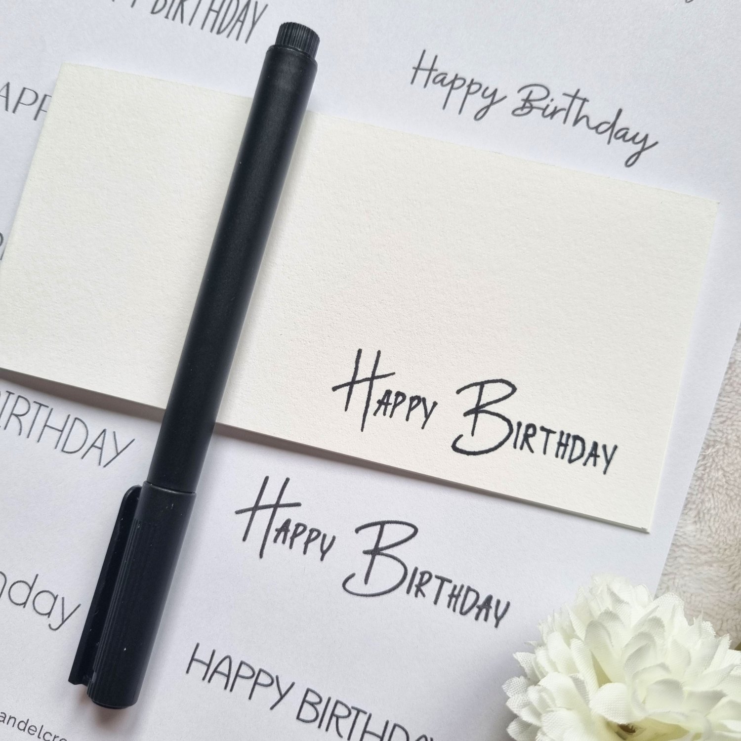 Printable sheet with card making sentiments and black ink pen on it.