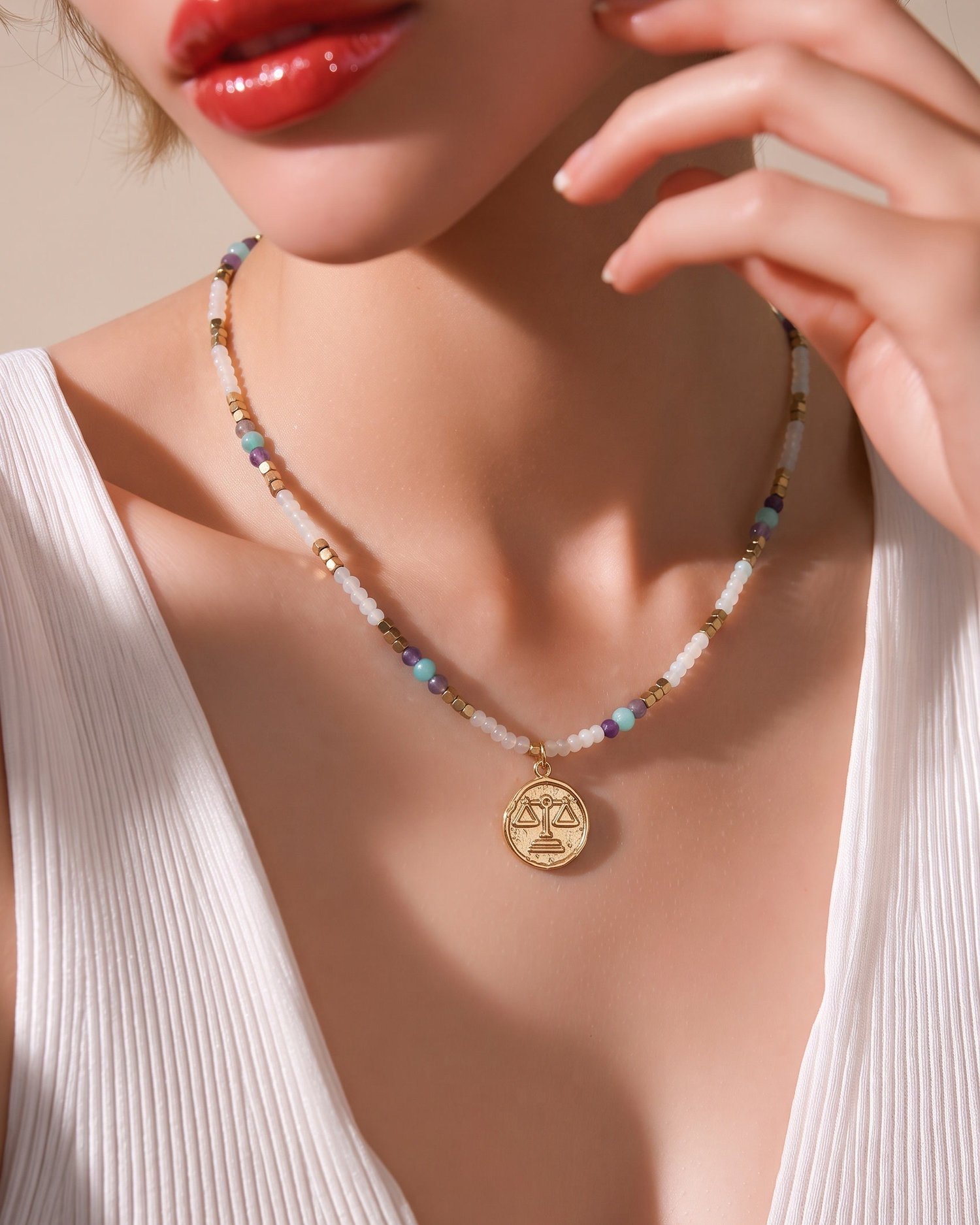 Collana Bilancia in pietre naturali indossata con abito bianco