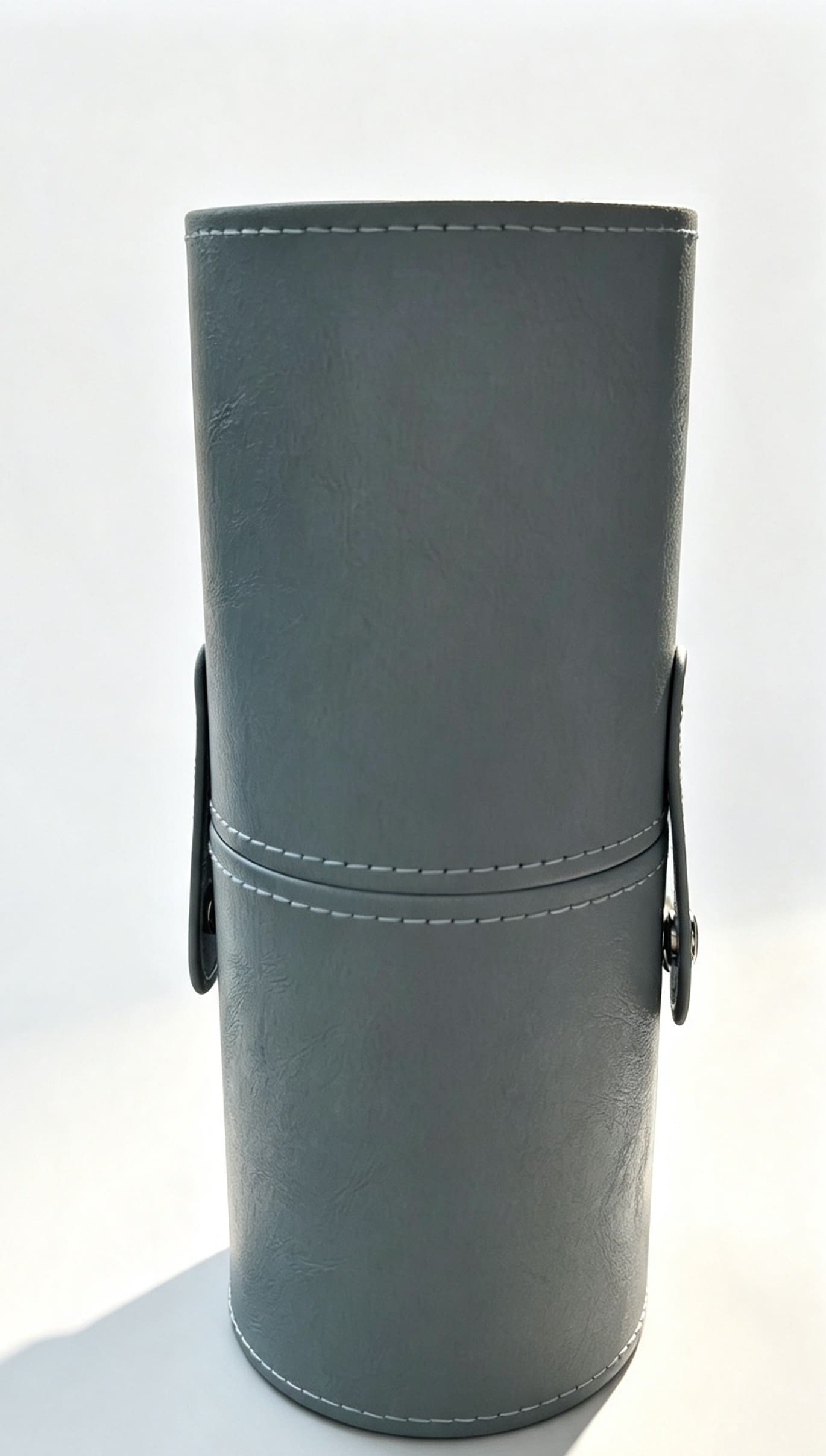 Luxury blue faux leather cylinder bridal makeup brush travel case with side snap closures.