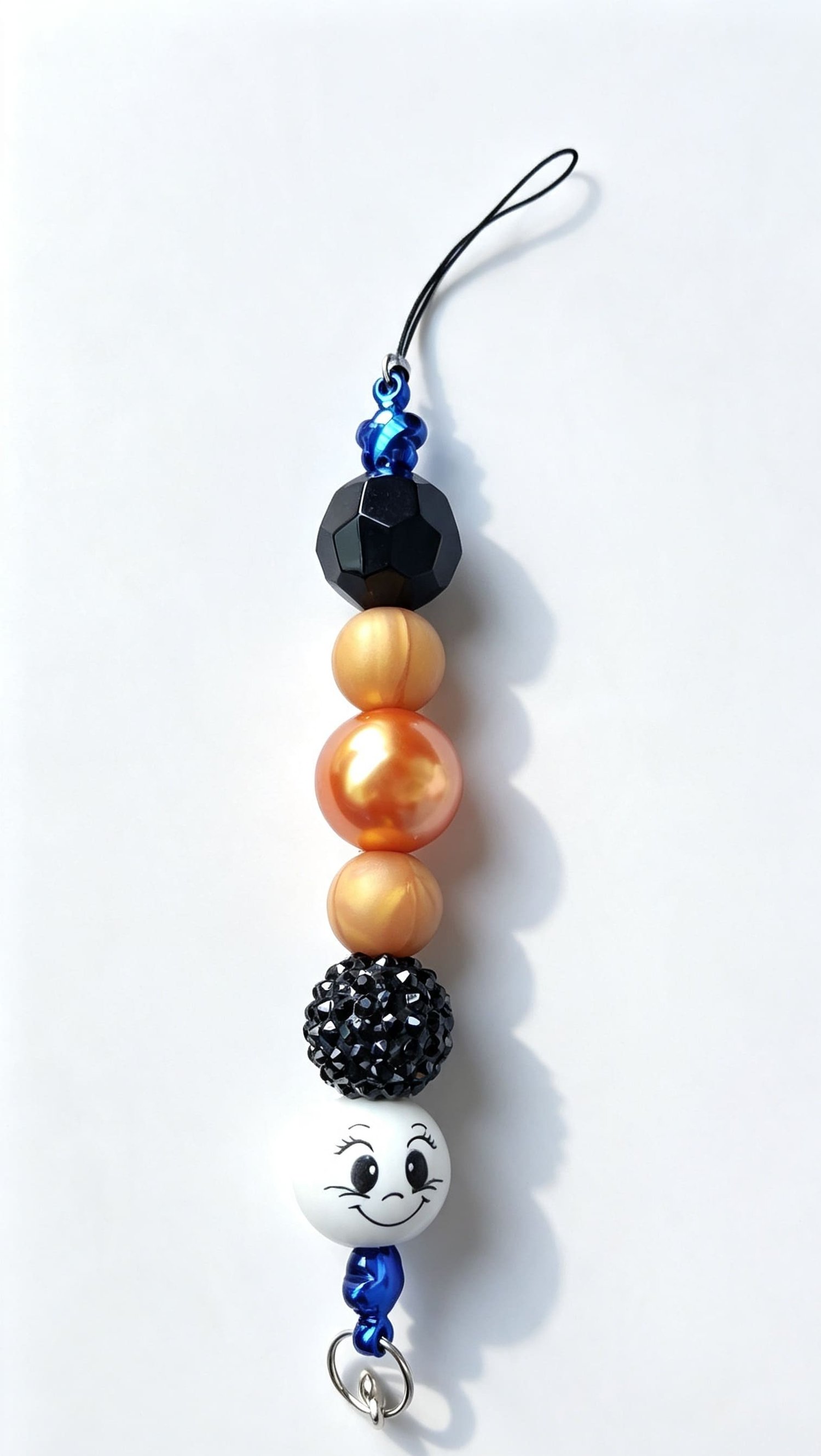 Handmade retro smiley face phone strap with orange, black and metallic blue beads and black cord loop