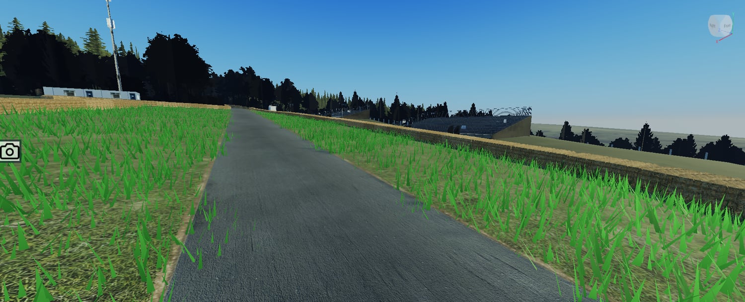 Wide racing circuit with sponsor boards and grass areas