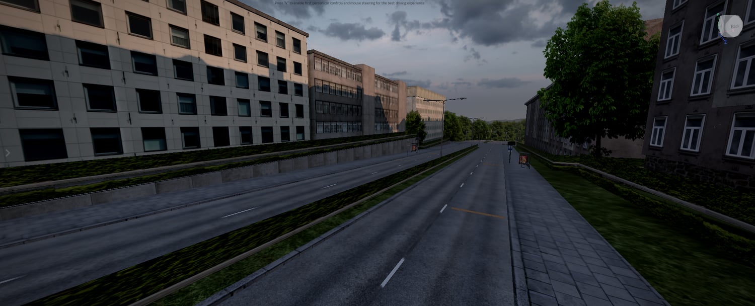 Dense urban street with buildings traffic lights and road markings