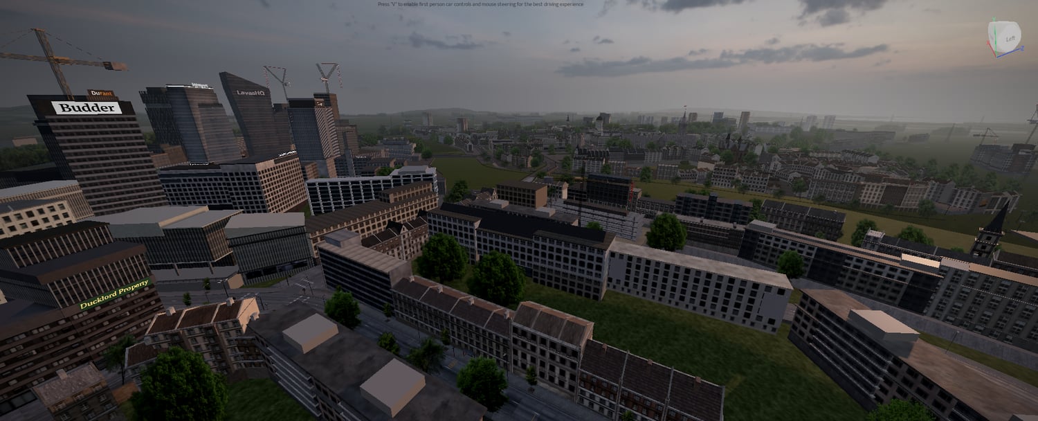 Large cityscape with high-rise buildings roads trees and surrounding terrain