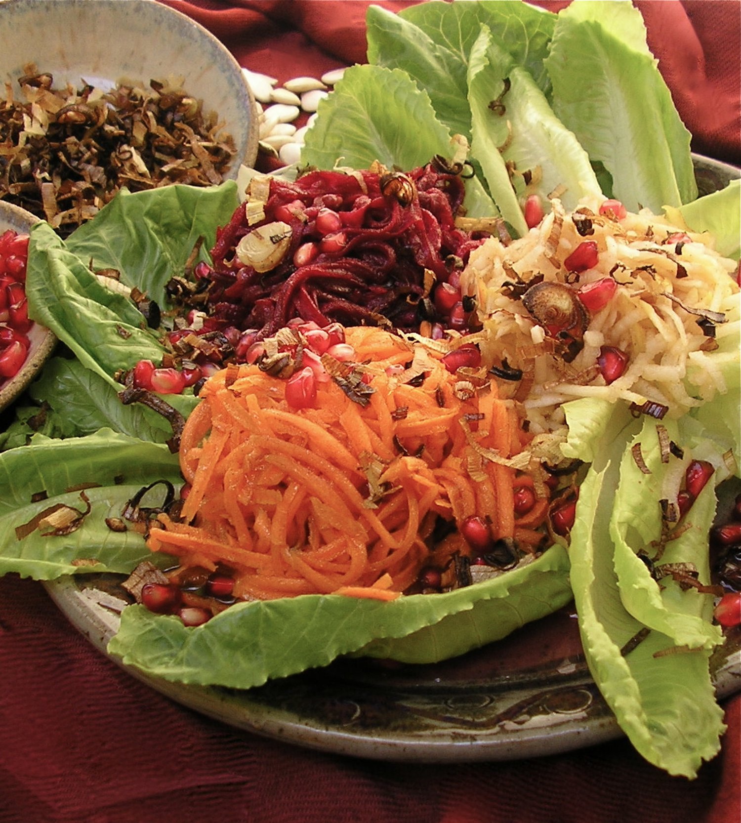 Queen in the Kitchen Royal Recipes & Tips for a Sweet New Year by Renee Chernin On Rosh Hashanah, we dress the table in white, we bring out our finest, and we serve dishes rich in meaning and intention. The foods we eat become our prayers. Each siman—carrot, beet, leek, date, apple, pomegranate—is a vessel for a heartfelt request: for sweetness, protection, abundance, clarity. These are not mere customs; they are actions filled with spiritual energy. The Simanim Salad gathers all those symbolic ingredients in one vibrant, jewel-toned dish. It’s more than a salad—it’s a statement of hope, a taste of blessing to begin the new year. Simanim Salad All of the “signs” in one jewel-toned salad. The perfect way to begin your yom tov meal! Prepare the components ahead and assemble just before serving. Dressing: 2 tablespoons + ¼ cup vegetable oil Juice of one small lime 3 tablespoons honey 1 tablespoon raspberry jam or fruit spread 1 teaspoon cinnamon ½ teaspoon salt ¼ teaspoon black pepper Salad: 2 leeks (white part only), washed well and sliced thinly 3 carrots, peeled and shredded 1 beet, peeled and shredded 1 apple, peeled and shredded 3 dried dates, pitted, diced Pomegranate seeds (optional) Toasted pumpkin seeds (optional) Instructions: 1. In a small bowl, whisk together the 2 tablespoons of oil, lime juice, honey, jam, cinnamon, salt, and pepper. 2. In a small pan, heat the ¼ cup of oil until it just begins to smoke, about 5 minutes. Fry the leeks in the oil until golden brown, 3–5 minutes. Drain on paper towels until cool. 3. In a medium bowl, toss the shredded carrots, beets, and apple with just enough dressing to coat. Toss them either separately to maintain their colors, or all together so that the apple and carrot will take on the ruby tint of the beets. Refrigerate until cold. 4. When ready to serve, assemble the salad: Either on individual plates or on a serving platter, mound the carrots, beets, and apple, sprinkle with the seeds and dates, and top with the fried leeks. Serve extra dressing on the side. Makes 8–12 servings Active time: 20 minutes PREPARE AHEAD: You can prepare the dressing up to 5 days ahead of time. Store it tightly covered in the refrigerator. The fried leeks will keep in the freezer (in a plastic bag) for up to 2 weeks. The tossed shredded carrot, apple, and beets will stay fresh in the fridge for up to 24 hours. Queen in the Kitchen Fish Tips Whether it is a matter of location or one of convenience, purchasing fresh fish is often not an easy option. I am regularly asked, “Is fresh always best?” Maybe, maybe not. Unless you caught the fish yourself, you really have no way of knowing exactly how fresh it is. Nowadays fish is often frozen within hours of a catch, and this method can even result in a superior product to the fresh fish at your local market. But choosing really fresh fish is easy if you know what to look for: • Smell it: fresh fish should smell fresh, like cucumbers. • See it: the flesh color should be vibrant, the skin shiny and metallic. • Any liquid from fresh fish should be clear and not milky. With these tips, you can also make the most of your frozen fish purchase: • Purchase only vacuum-packed fish or fish labeled “flash” or “quick” frozen. This means they were frozen within hours of the catch. • The best varieties to buy frozen are salmon, tilapia, halibut, and flounder. • Thaw fish slowly in the refrigerator. Thawing under water or in the microwave diminishes the flavor and texture of the fish. • After thawing, drain, rinse, and pat fish dry before preparing. Brown Sugar Salmon The sweet and salty combination in this recipe brings out the natural flavor of the fish and its simple preparation adapts to many presentations. 3 pounds salmon fillet 3⁄4 cup brown sugar 4 tablespoons tamari or soy sauce 1 tablespoon lemon juice 1. Combine all the ingredients and marinate in a tightly covered storage container in the refrigerator for 30 minutes to overnight. 2. Preheat the oven to 350° F. Line a baking pan with foil. Transfer the fish from the container to the baking pan, discarding the marinade. Bake until the center is opaque and flaky, about 20 minutes. Do not overbake. QUEEN IN THE KITCHEN TIP: Smaller fillets require less time in the oven than a whole fillet. Bake just until fish is firm and opaque, and flakes with a fork. Makes 10–15 servings Active time: 5 minutes Cooking time: 20 minutes PREPARE AHEAD: Brown Sugar Salmon will keep in the refrigerator, tightly covered, for up to three days. Queen in the Kitchen Honey Cake A Queen in the Kitchen recipe is adaptable and forgiving, just as a wife and mother must be. This honey cake, my version of Marcy Goldman’s famous Definitively Moist and Majestic Honey Cake, is both. It is a sweet and tender cake with just the right spice—also essential characteristics for the Queen of a Jewish home. This cake is best made a day or two ahead. 31⁄2 cups all-purpose flour 1 teaspoon baking powder 1 teaspoon baking soda 1⁄2 teaspoon salt 2 teaspoons ground cinnamon 1 teaspoon ground cloves or ginger 1 teaspoon ground allspice 1 cup oil 1 cup honey 3⁄4 cup sugar 3⁄4 cup light brown sugar 4 eggs, room temperature 1 teaspoon vanilla 1 cup coffee, strong black tea, or flat cola 1/3 cup orange or apple juice 1/3 cup bourbon or rum, or substitute with one of the above liquids 1⁄2 cup raisins, dried cranberries, or chocolate chips (optional) 1. Preheat the oven to 350° F. Prepare either two 9x9-inch cake pans, one 9 x-13-inch cake pan, three loaf pans, or one 9-inch tube pan (see tip on page xxx). It is also recommended to line the bottom of the pan with parchment paper. 2. In a large bowl, whisk together the flour, baking powder, baking soda, salt, cinnamon, cloves or ginger, and allspice. Make a well in the center, and pour in the oil, honey, sugars, eggs, vanilla, coffee or tea, juice, and liquor. 3. With an electric mixer on slow speed, blend well, making sure that no ingredients are stuck to the bottom. Fold in the raisins, dried cranberries, or chocolate chips, if desired. The batter will be thick. 4. Spoon the batter into prepared pans. Place cakes on baking sheets in the oven (this helps to brown the bottoms properly). 5. Bake until the top springs back when pressed gently with your finger: for the sheet cakes and loaves, 40–55 minutes; for the tube or Bundt cake, 1–11⁄2 hours. 6. Let cool on a wire rack for 10–15 minutes, then gently invert cake onto a plate. Makes 20–30 servings Active time: 20 minutes Cooking time: About 1 hour Can freeze for up to 1 month PREPARE AHEAD: The flavor of this cake improves over two days. It will keep, tightly covered, for up to five days. Renee Rousso Chernin, author, recipe developer and creator of the website, TheKosherChannel.com, centers her work on the connection between the practical and inner lives of today’s Jewish woman. Her articles have appeared in dozens of publications and she has published two editions in her series of holiday cookbooks titled Cooking for the King. Renee and her husband David made aliyah in 2007 from Atlanta, Georgia. After 13 years in the Old City of Jerusalem, they now live in Nof Tzion. They are blessed with two married daughters who are amazing moms and cooks, and the cutest grandchildren on earth.