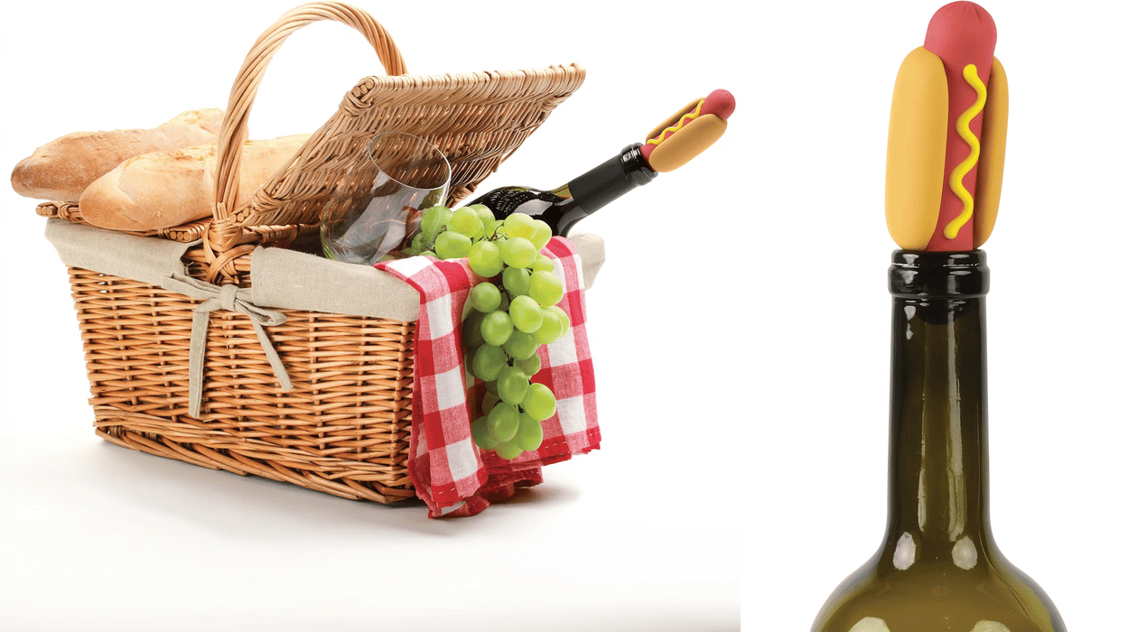 Hot dog wine bottle stopper shown on a wine bottle with a picnic basket and wine setting