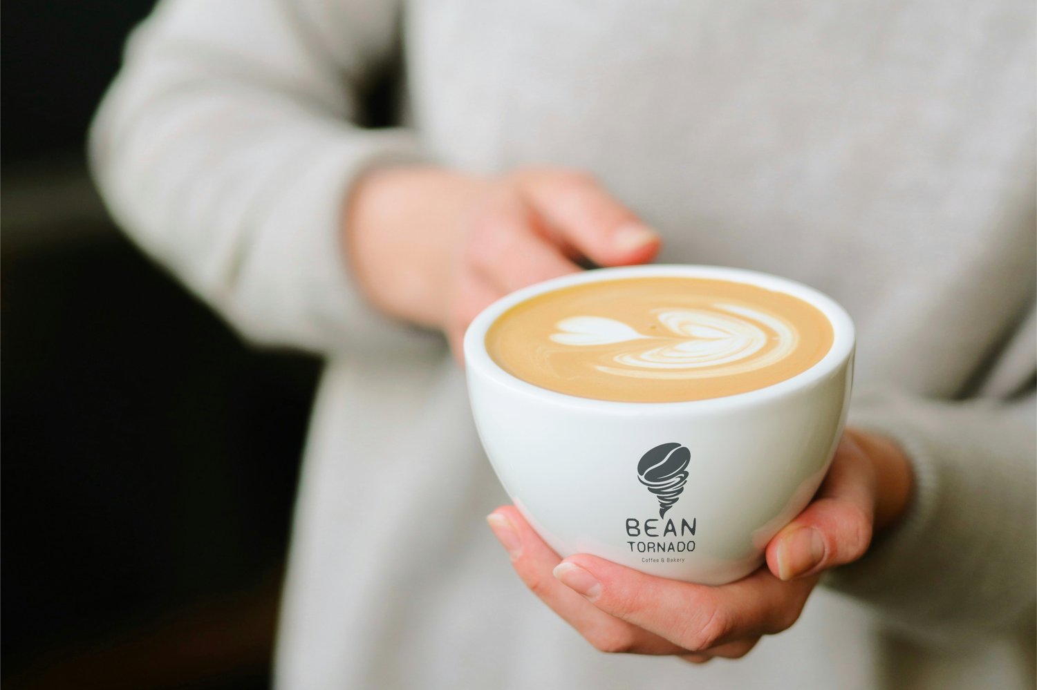 Coffee cup mockup with custom logo design and latte art
