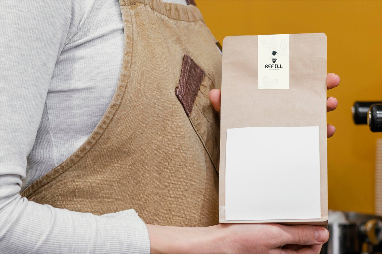 Coffee bag packaging mockup held by barista