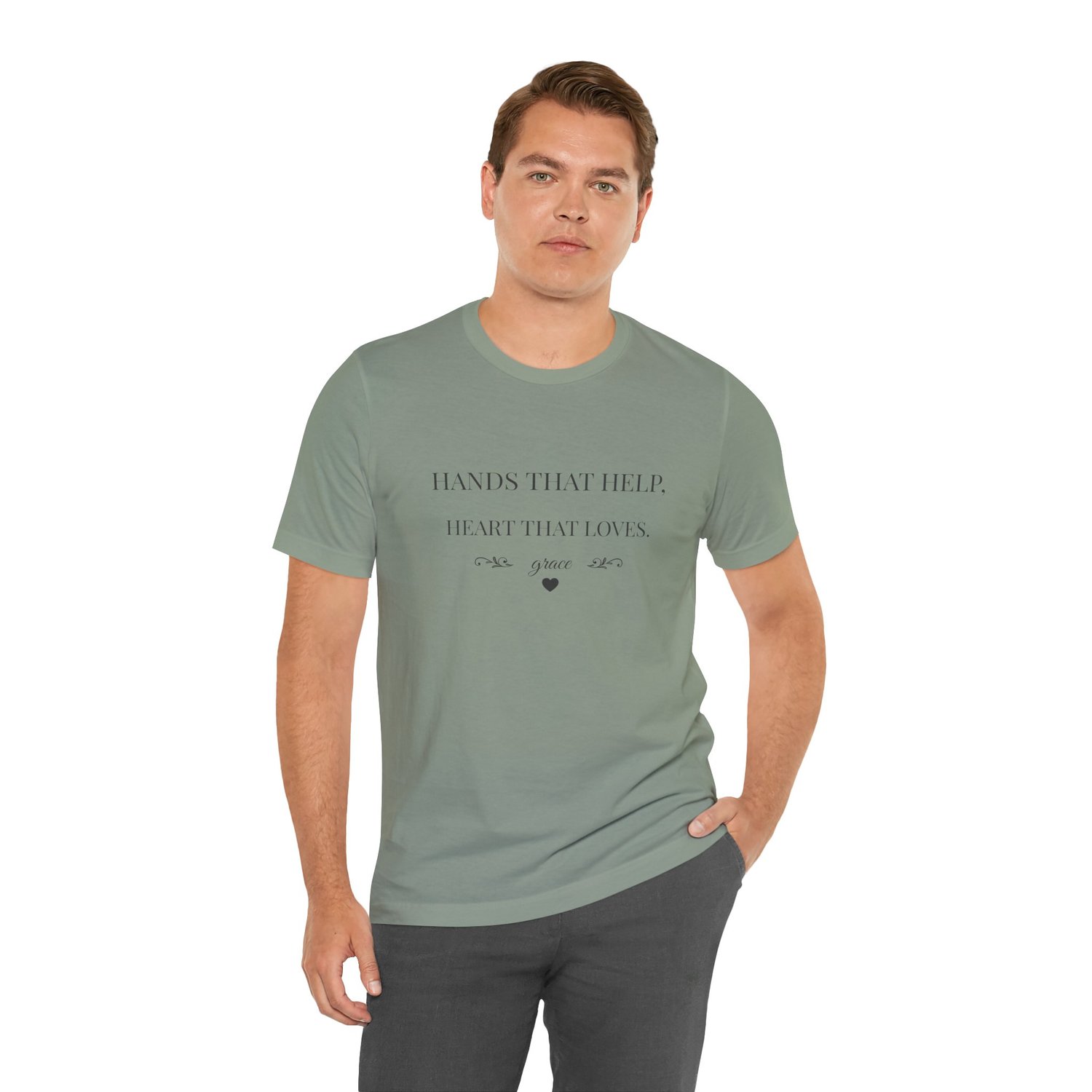 Caregiver shirt Hands That Help Heart That Loves modeled standing in Sage.