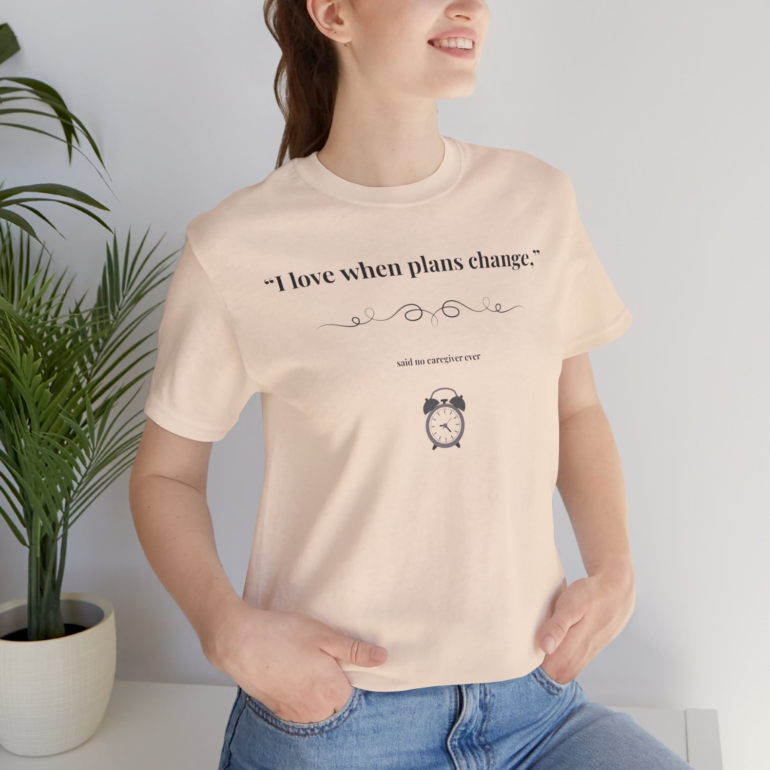 Woman wearing vintage white tee with "I love when plans change" design