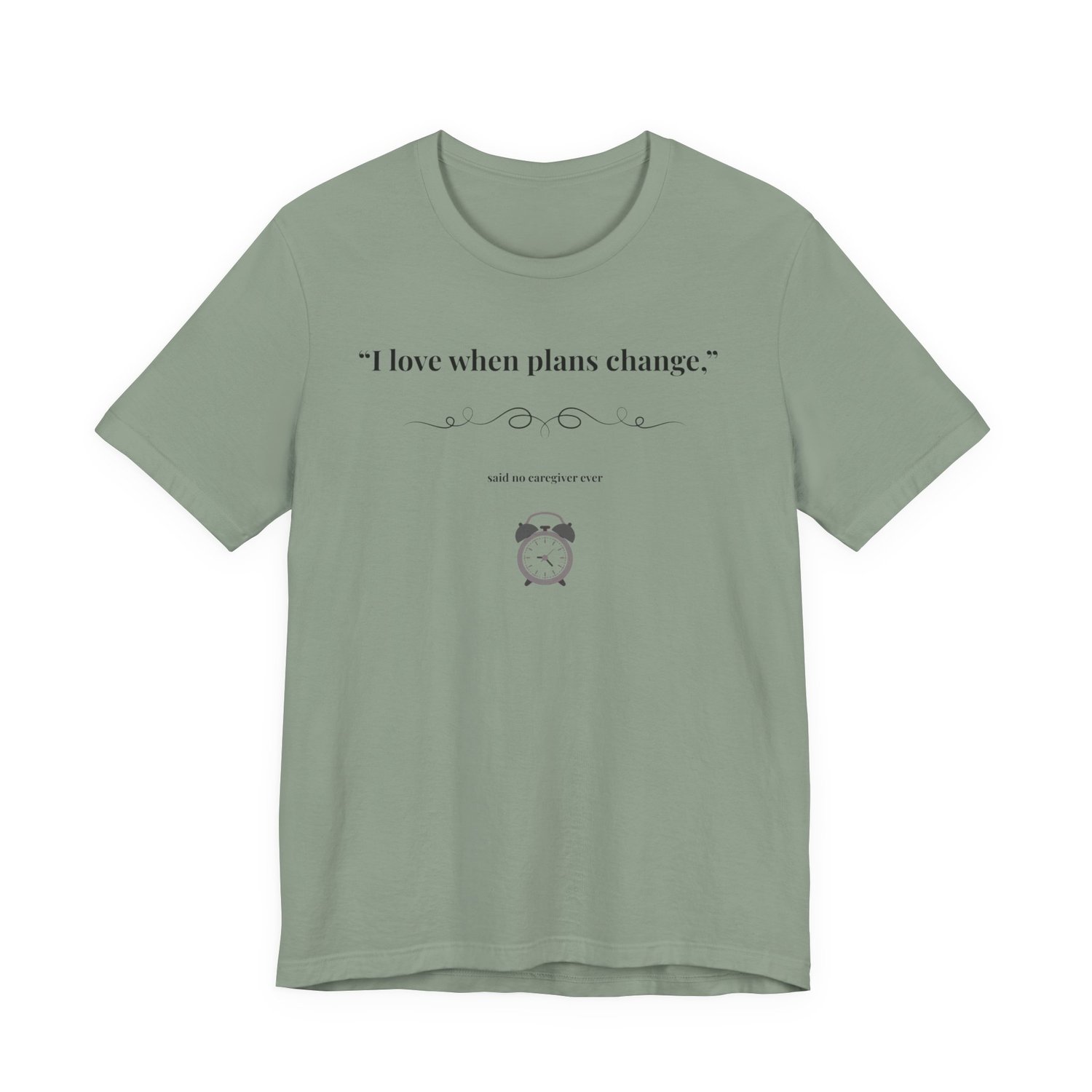 Sage shirt flat lay – “I Love When Plans Change” caregiver design.