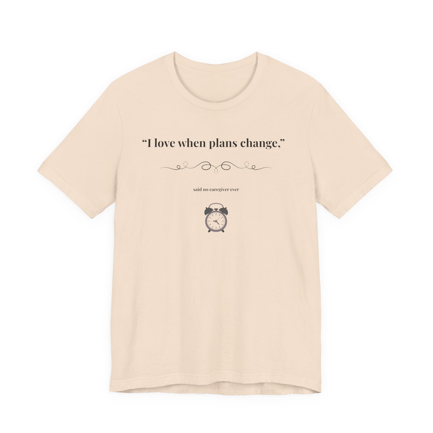 Soft Cream shirt flat lay – “I Love When Plans Change” caregiver design.