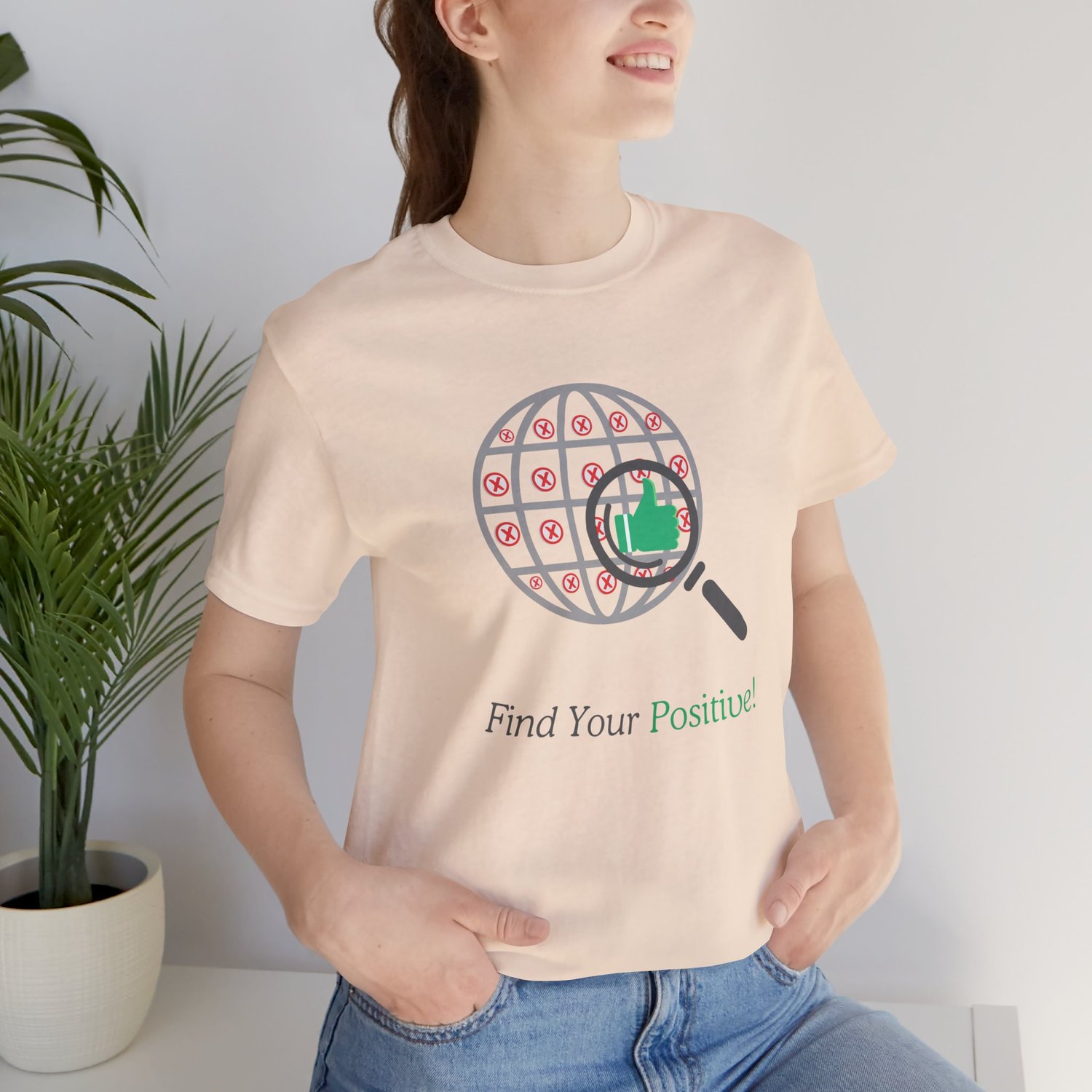 Woman wearing the ‘Find Your Positive’ tee, showing the front design in a casual lifestyle setting.