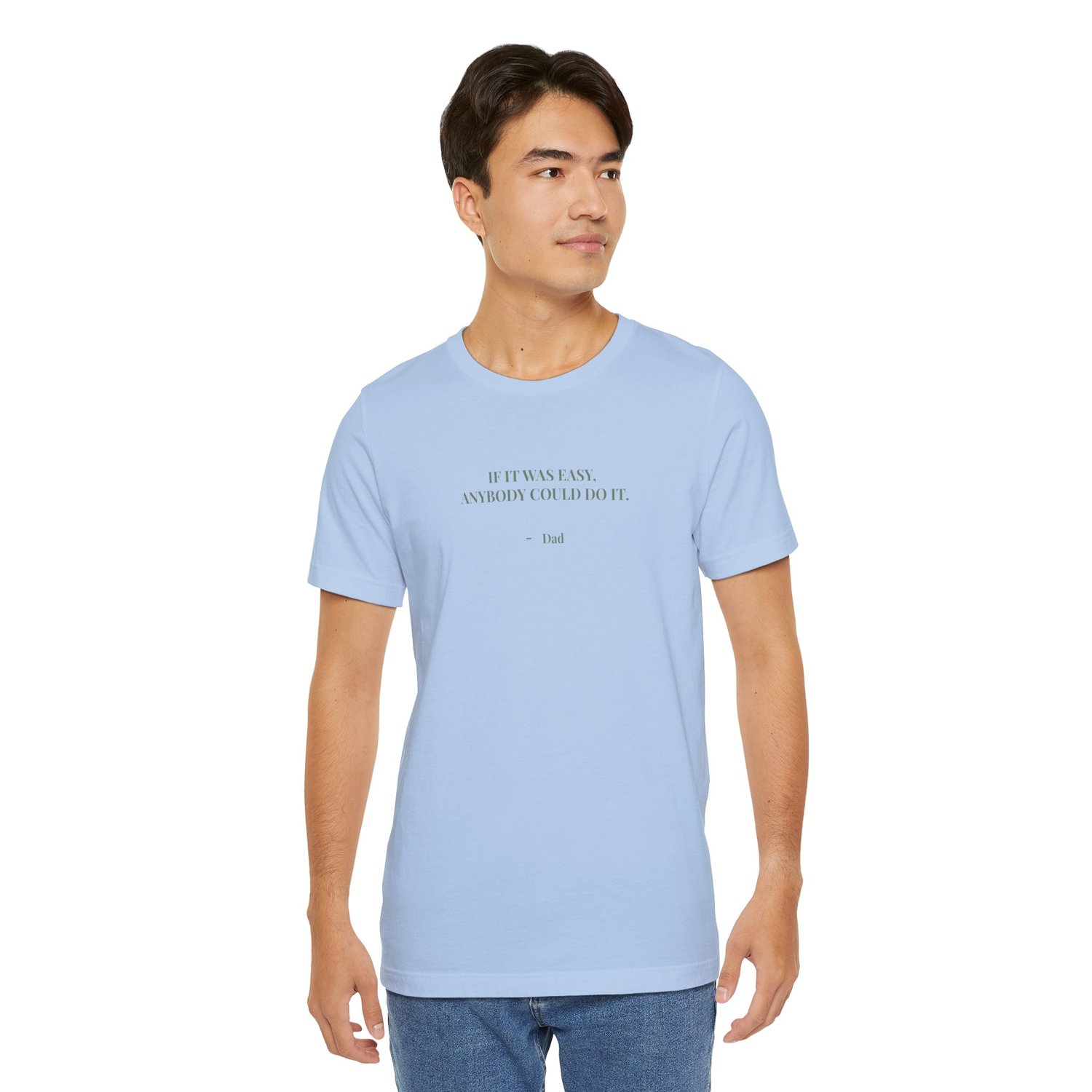 Man standing and wearing a blue t‑shirt featuring the quote ‘If it was easy, anybody could do it. — Dad.