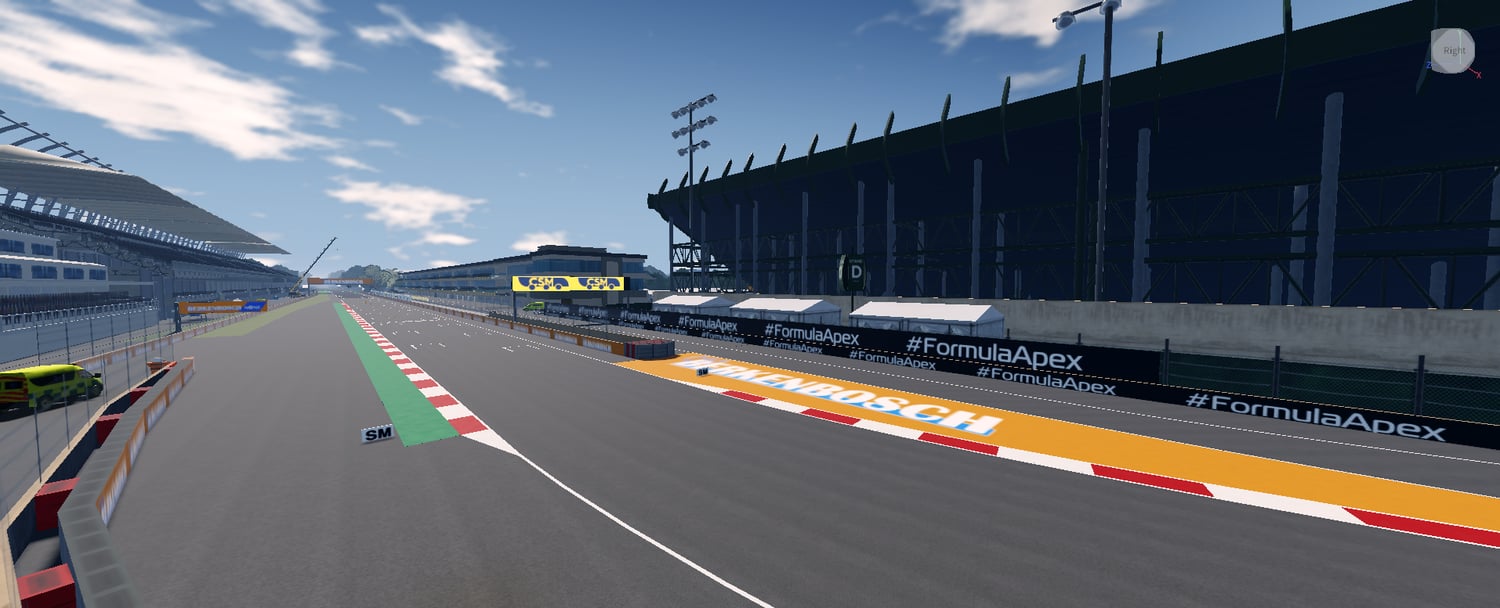 Main racing straight with pit buildings and overhead signage