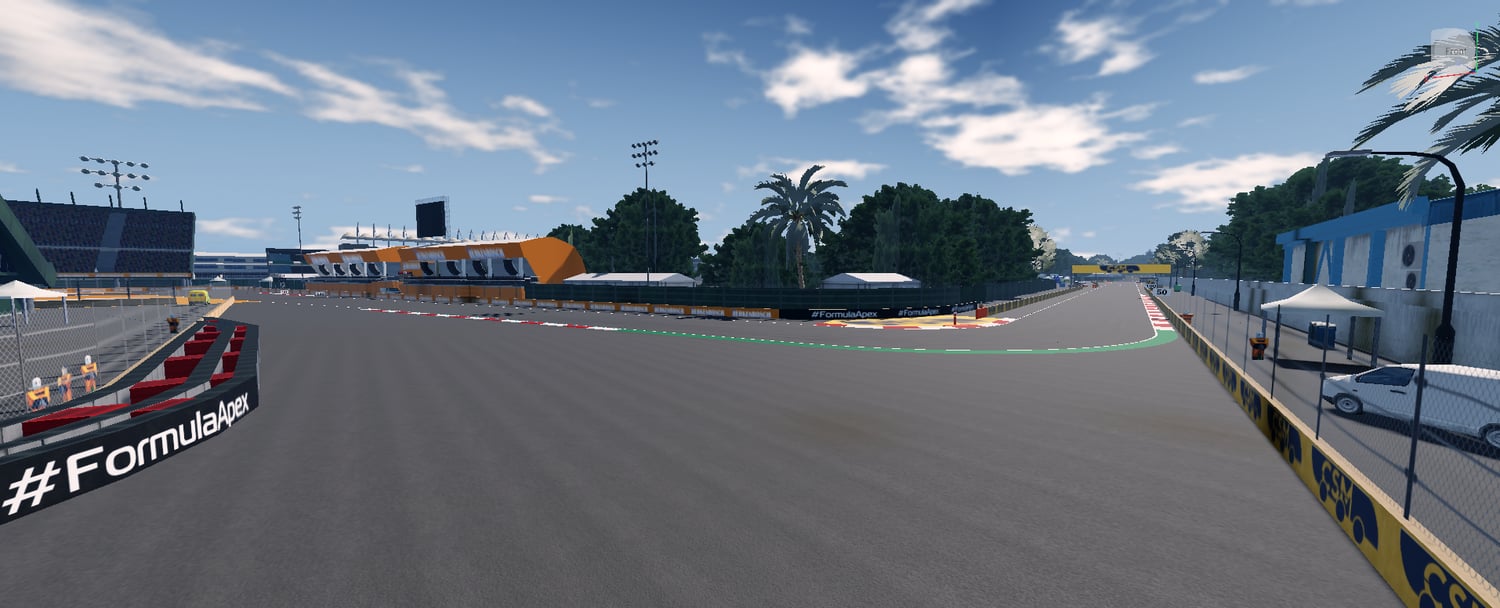 Wide Formula racing circuit surrounded by spectator seating