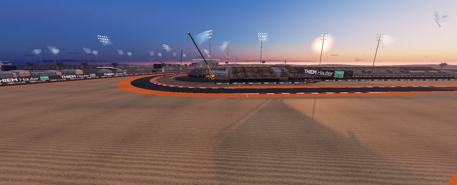 Racing corner with colored runoff zones and floodlights