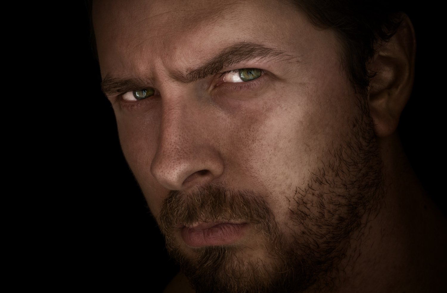 stock image photo of a man with a suspicious expression; is he hiding something? or is he trying to figure out if you are?