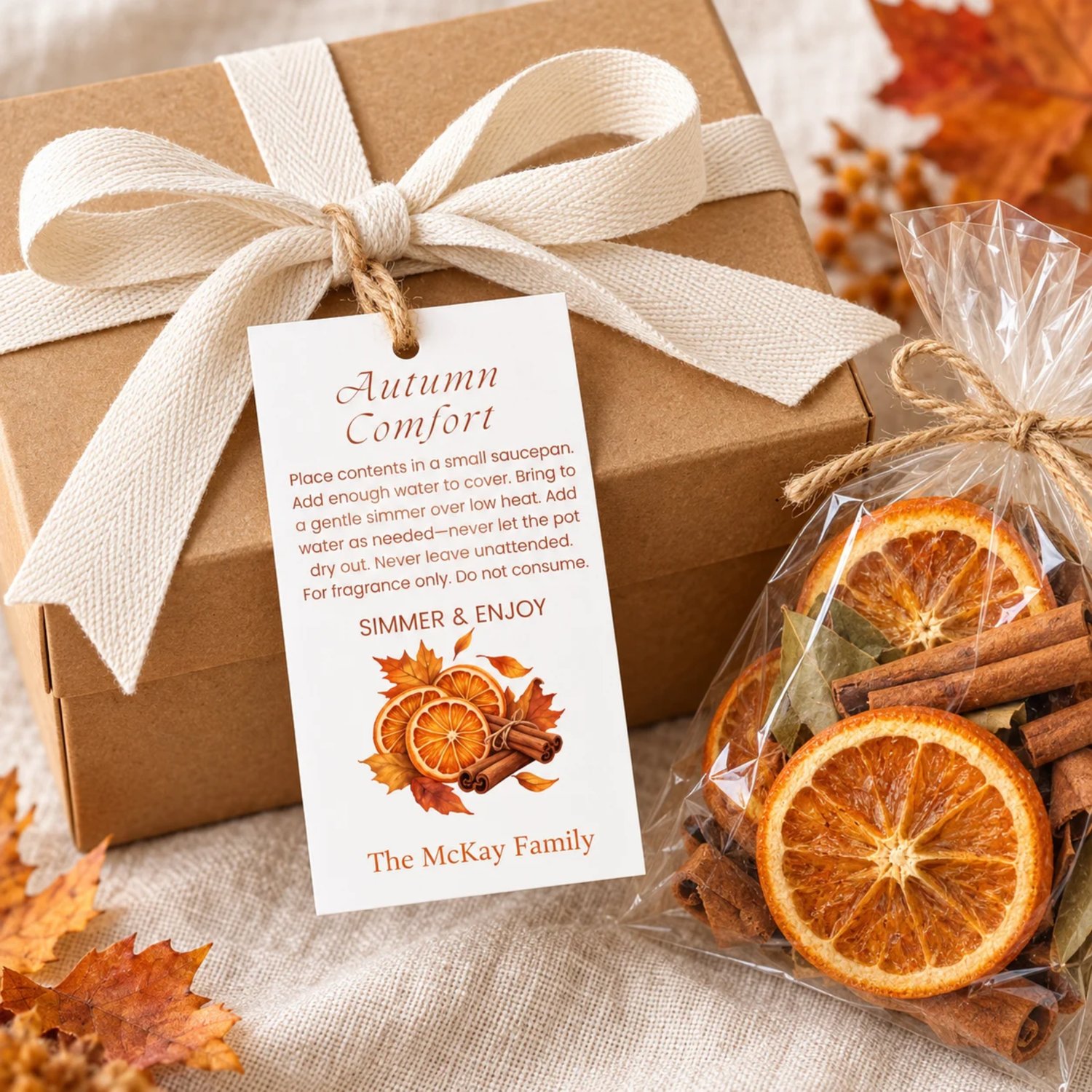 Sheet of eight Autumn Comfort potpourri gift tags with orange slices, cinnamon sticks, fall leaves, simmering instructions, and a family name on white.