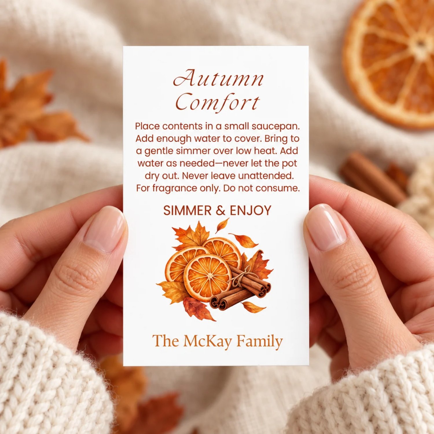 Sheet of eight Autumn Comfort potpourri gift tags with orange slices, cinnamon sticks, fall leaves, simmering instructions, and a family name on white.