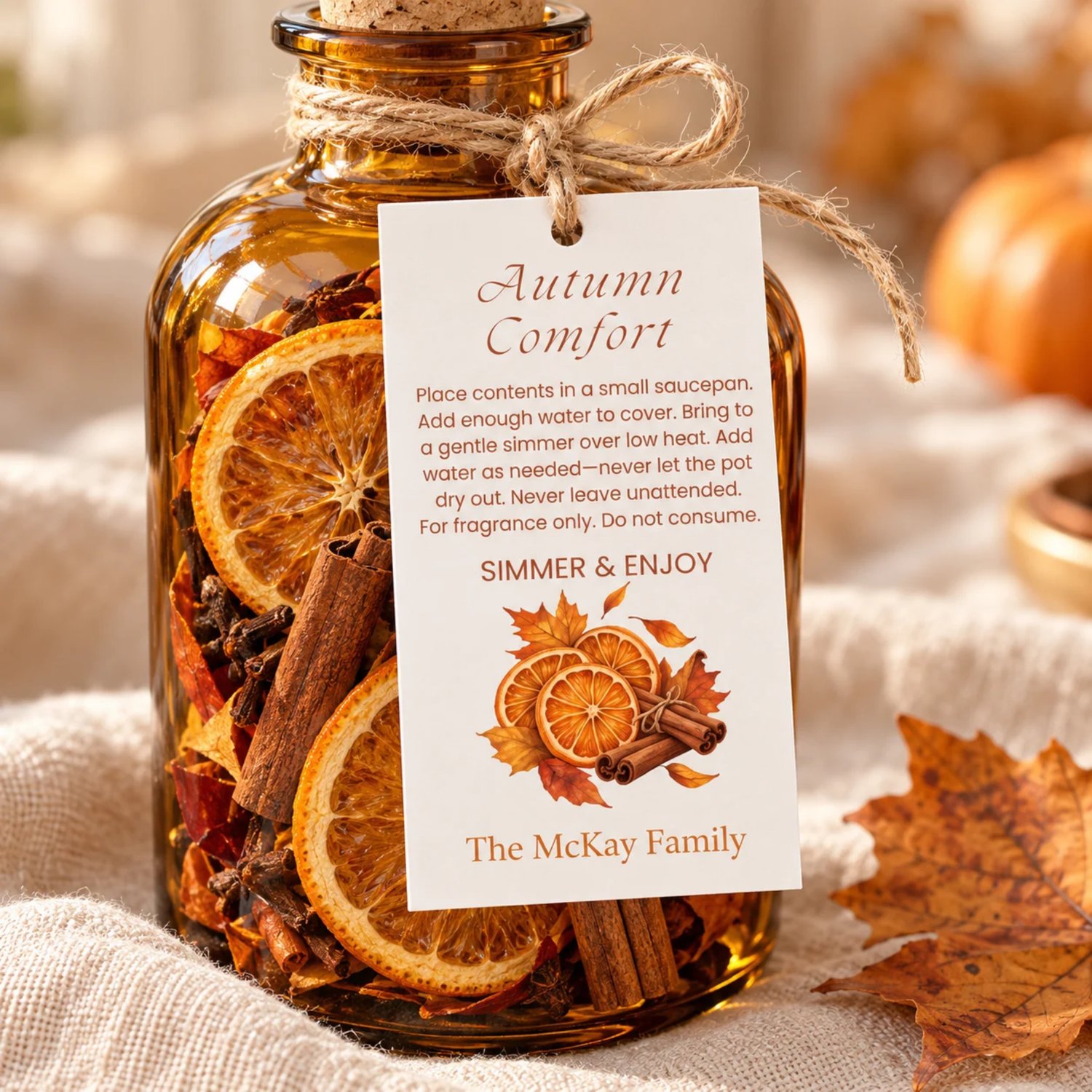Sheet of eight Autumn Comfort potpourri gift tags with orange slices, cinnamon sticks, fall leaves, simmering instructions, and a family name on white.