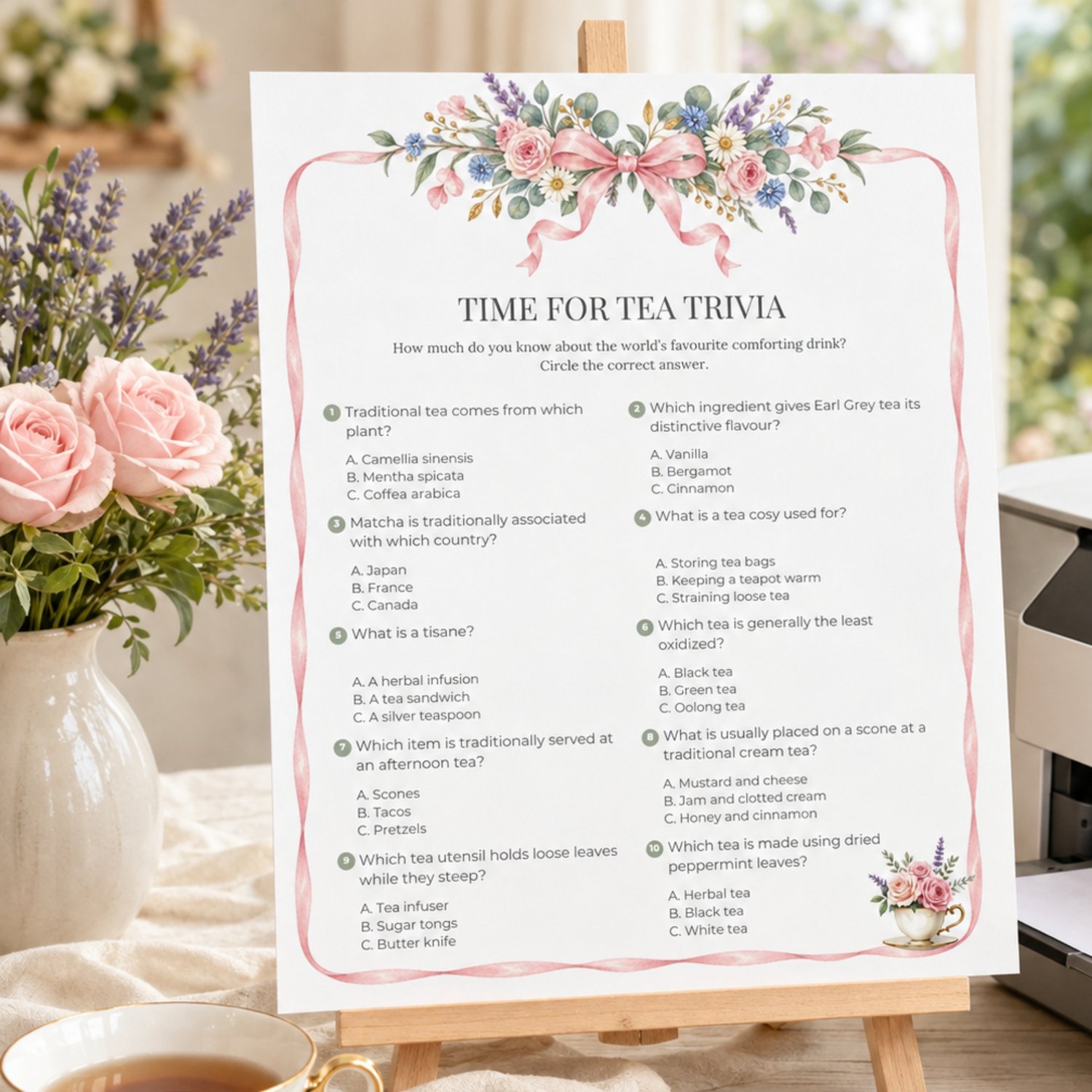 Printable Garden Tea Party Trivia Game with 10 multiple-choice tea questions, watercolor pink ribbon and English garden flowers, floral teacup and answer sheet.