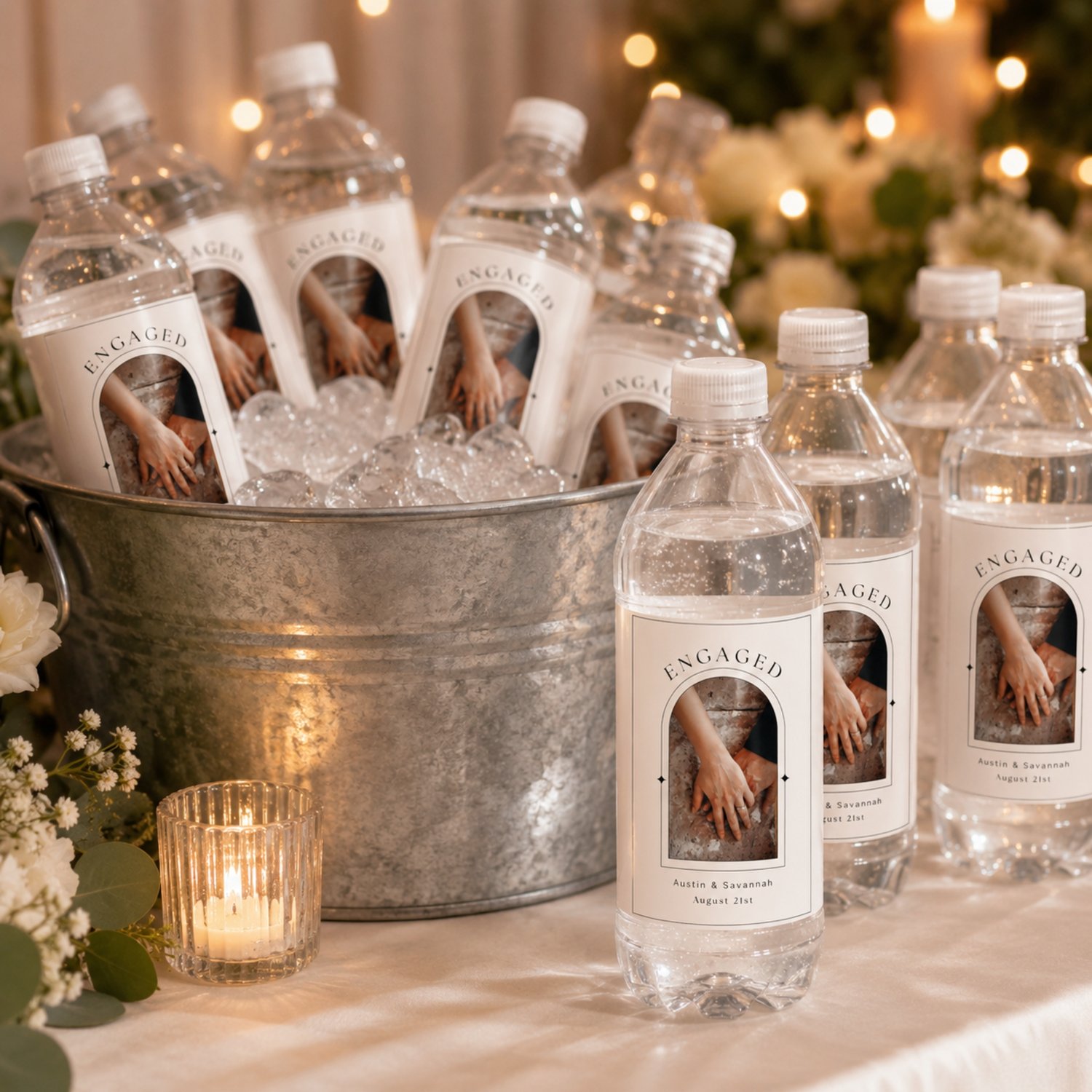 Editable 4 by 6-inch engagement bottle label template featuring a couple’s photo, names and date in a modern black-and-white arched design, with two labels arranged on a letter-size printable sheet.
