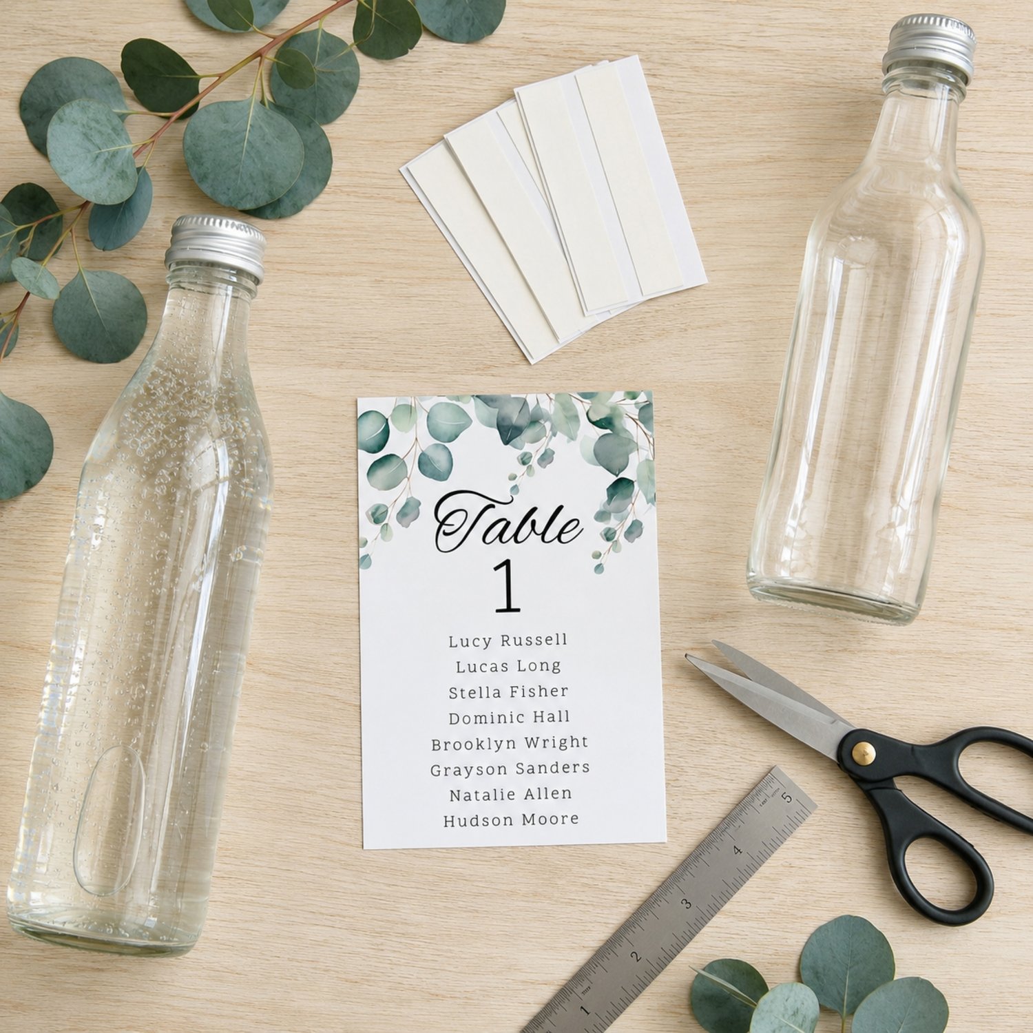 Editable eucalyptus wedding table seating bottle label template featuring watercolor greenery, table numbers and guest names. Includes one 4 by 6 inch rectangular label and a US Letter printing layout with two labels per page for DIY wedding reception déc