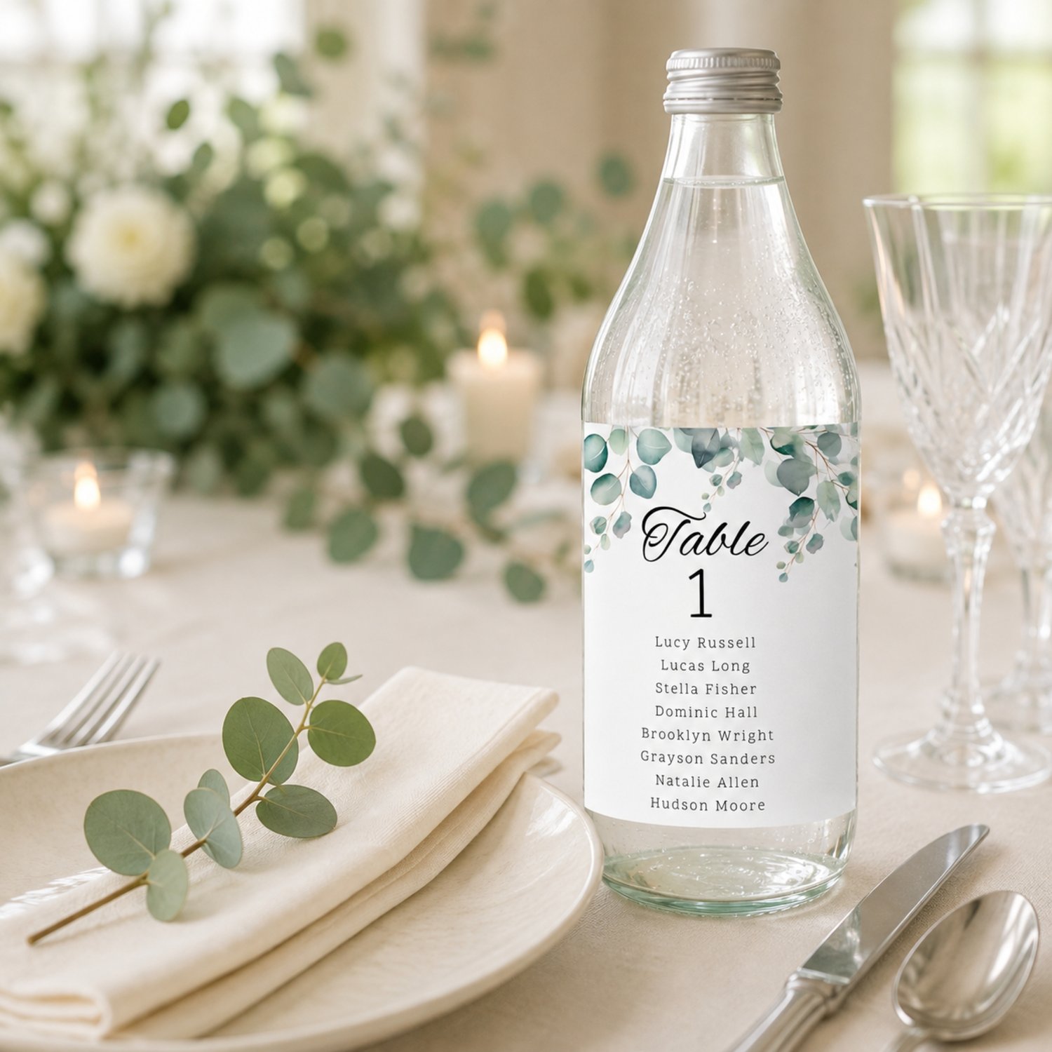 Editable eucalyptus wedding table seating bottle label template featuring watercolor greenery, table numbers and guest names. Includes one 4 by 6 inch rectangular label and a US Letter printing layout with two labels per page for DIY wedding reception déc