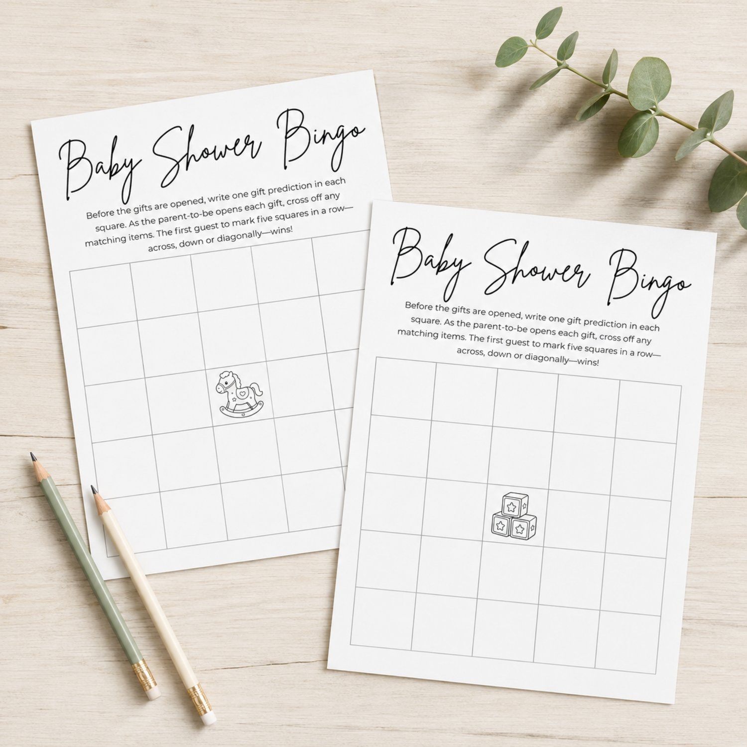 Two printable black-and-white Baby Shower Bingo cards featuring 5-by-5 blank grids, game instructions, and center free-space illustrations of a rocking horse and toy blocks.