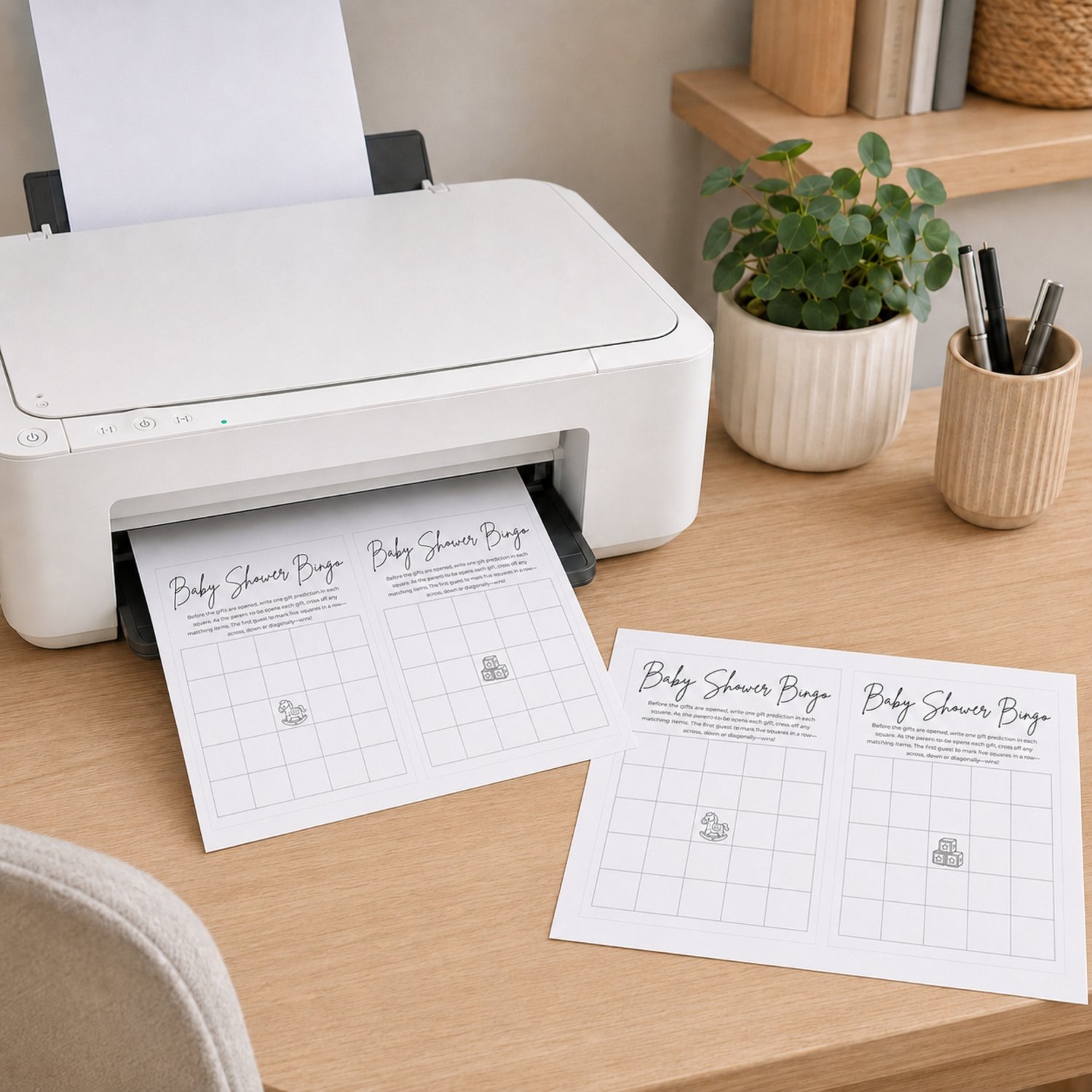 Two printable black-and-white Baby Shower Bingo cards featuring 5-by-5 blank grids, game instructions, and center free-space illustrations of a rocking horse and toy blocks.
