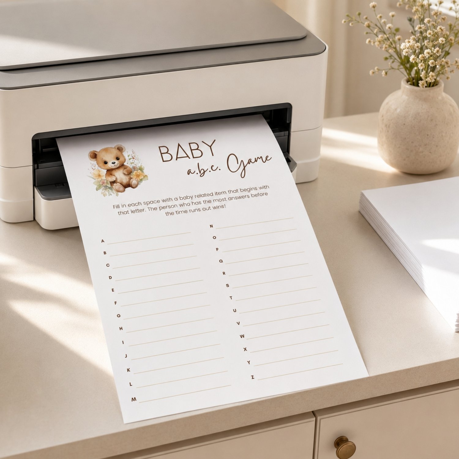 Printable Baby Shower ABC Game featuring a sweet watercolor teddy bear with neutral flowers, simple instructions and A-to-Z answer lines on a US Letter-size page.