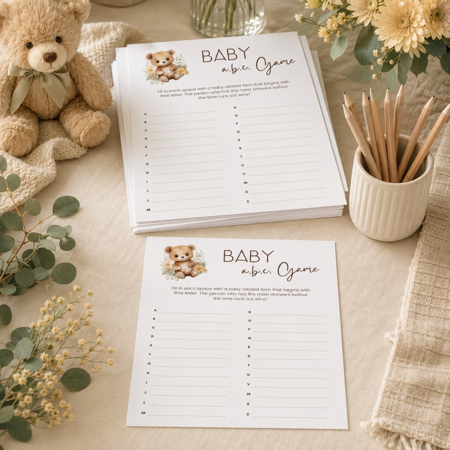 Printable Baby Shower ABC Game featuring a sweet watercolor teddy bear with neutral flowers, simple instructions and A-to-Z answer lines on a US Letter-size page.