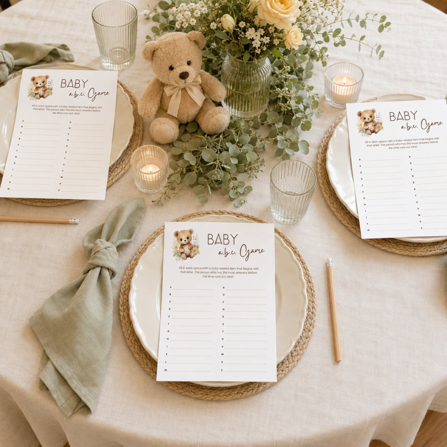 Printable Baby Shower ABC Game featuring a sweet watercolor teddy bear with neutral flowers, simple instructions and A-to-Z answer lines on a US Letter-size page.