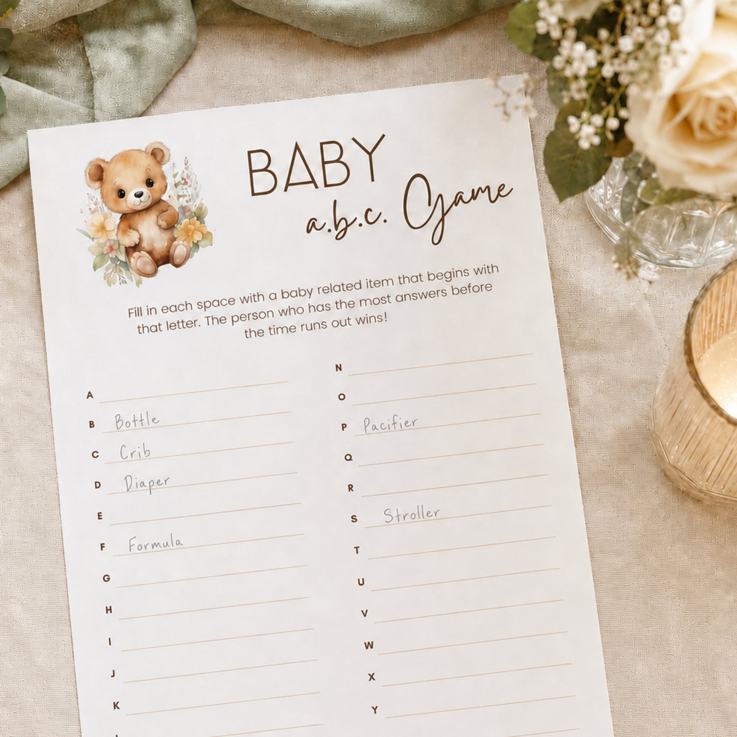 Printable Baby Shower ABC Game featuring a sweet watercolor teddy bear with neutral flowers, simple instructions and A-to-Z answer lines on a US Letter-size page.