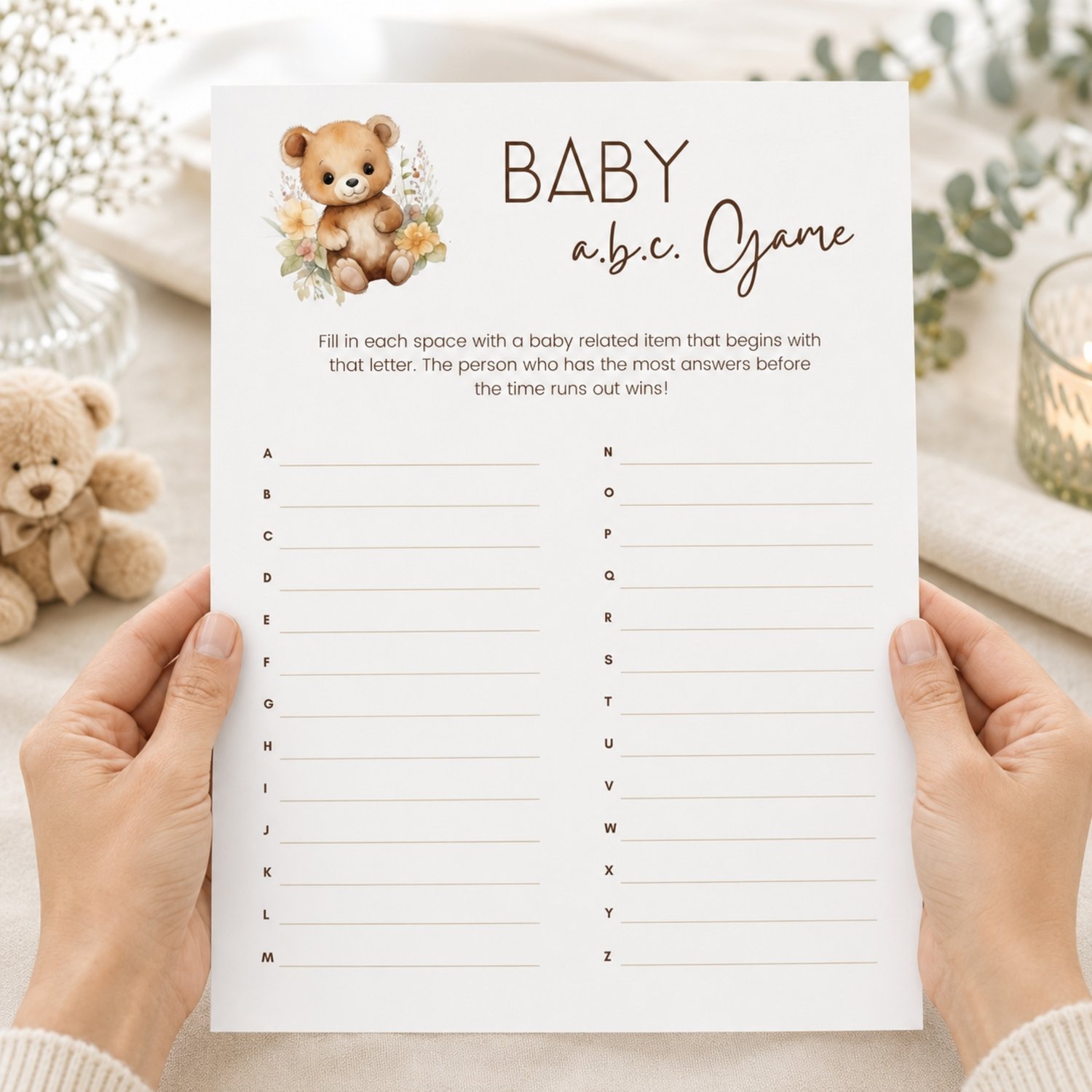 Printable Baby Shower ABC Game featuring a sweet watercolor teddy bear with neutral flowers, simple instructions and A-to-Z answer lines on a US Letter-size page.