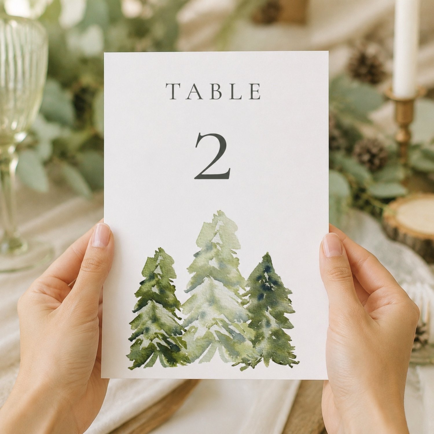 Editable 5 × 7-inch watercolor pine tree table number card featuring soft green woodland trees, elegant charcoal lettering and table numbers 1–30 for rustic, forest, mountain or outdoor weddings.