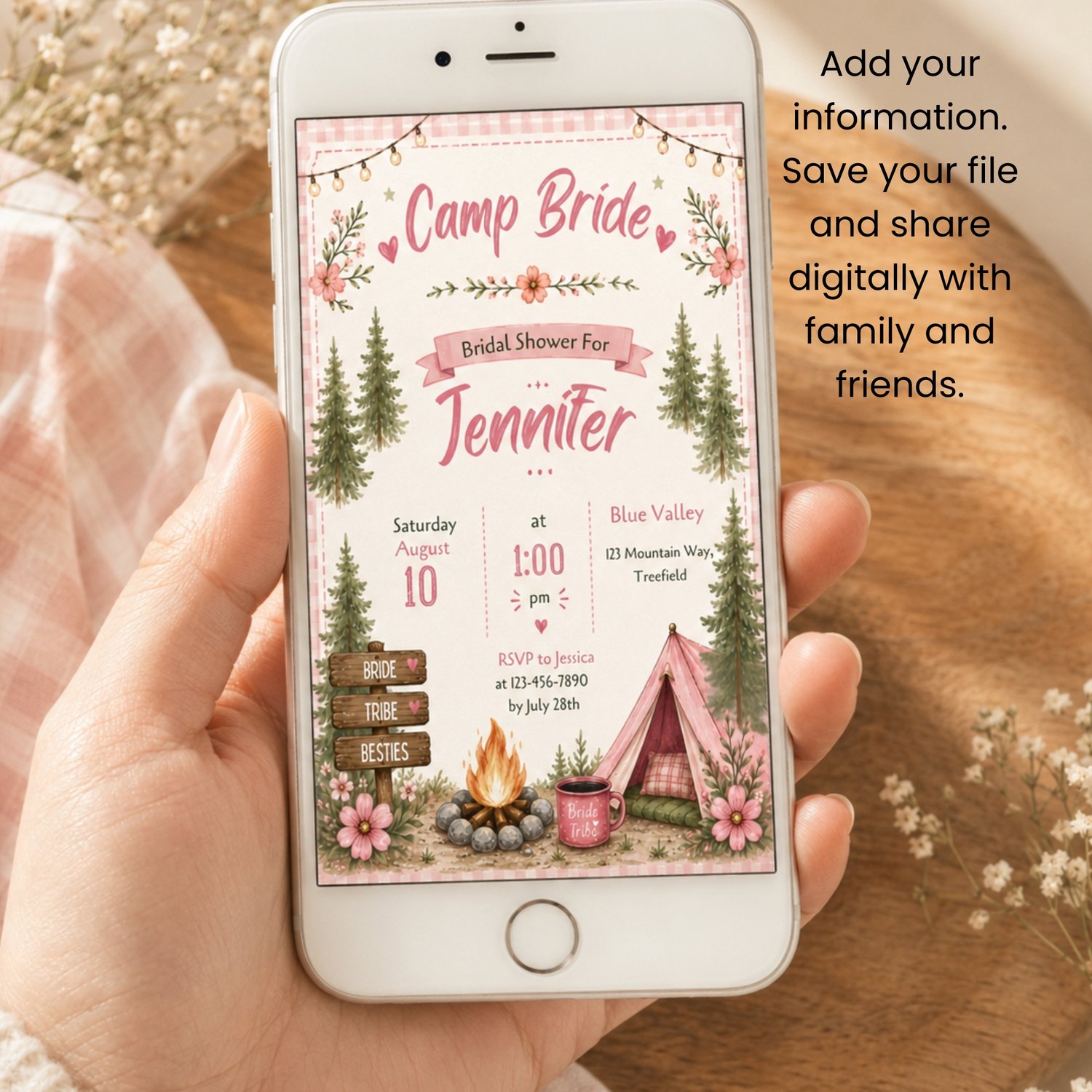 A rectangular bridal shower invitation with a pink gingham border, featuring the text Camp Bride, Bridal Shower. The design includes illustrations of pine trees, a campfire, a pink tent, and string lights. Edit in Canva.