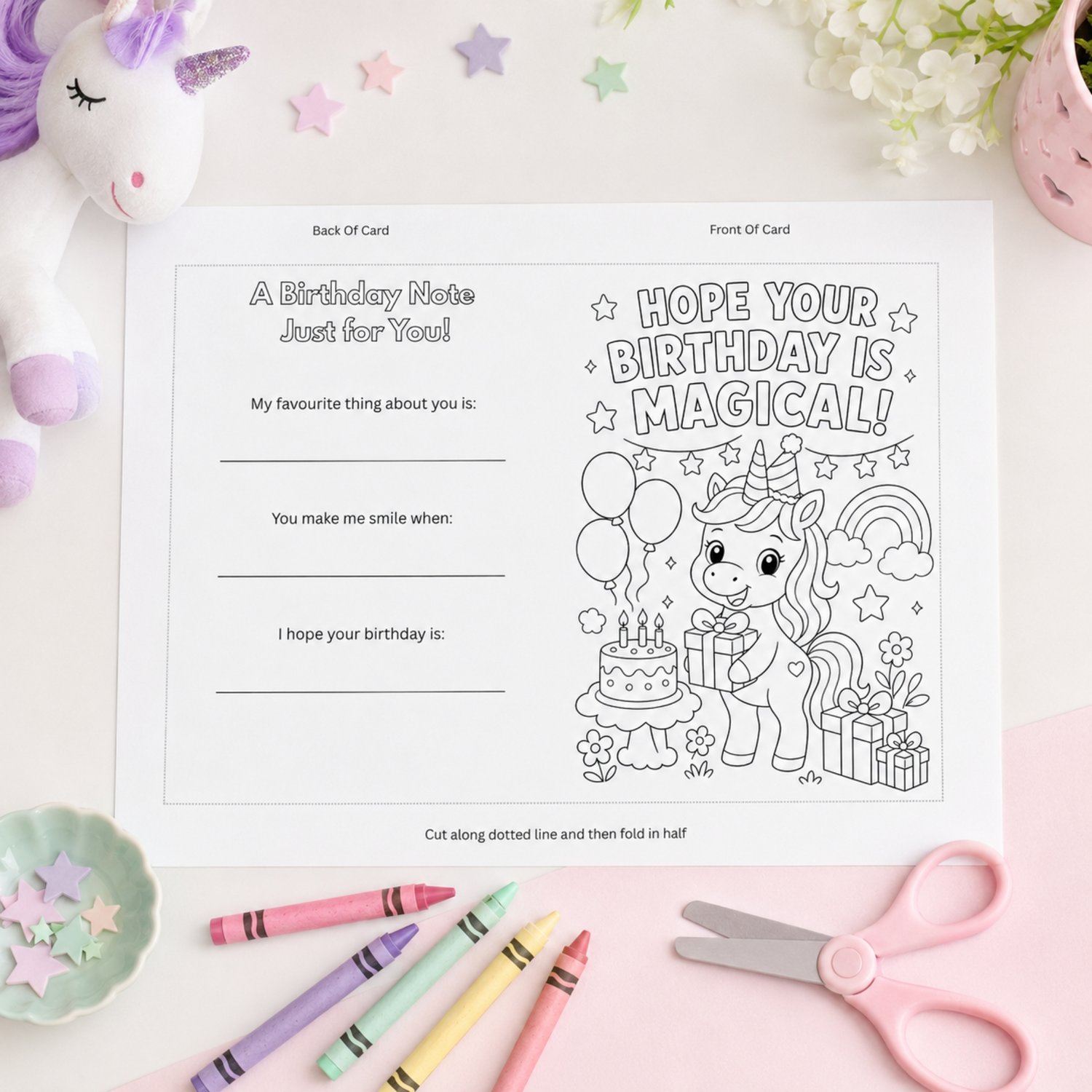 Printable 5 by 7 inch unicorn birthday coloring card featuring a cheerful unicorn, rainbow, balloons, cake, presents and the words Hope Your Birthday Is Magical. The back includes three fill-in birthday keepsake prompts for children.