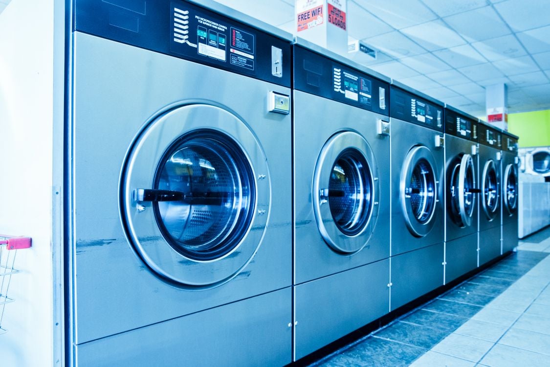 Stock photograph of commercial washing machines in a laundromat