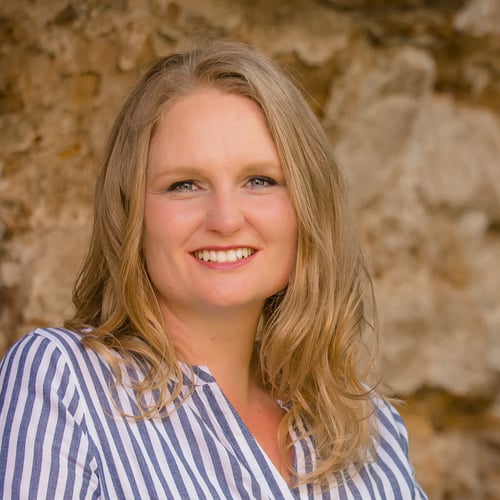 Talena Winters, a blond Caucasian woman in a blue striped shirt, smiles at the camera.