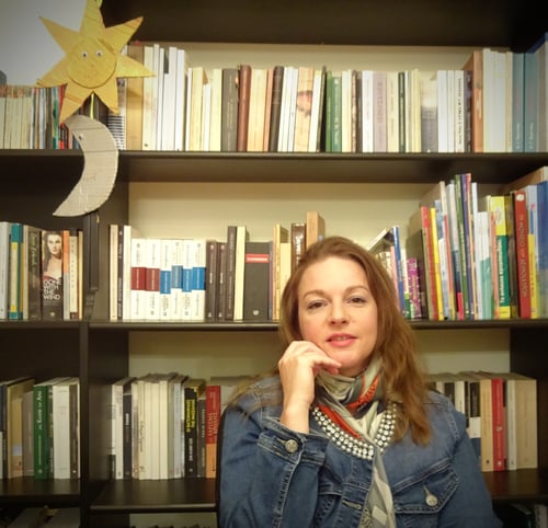 Marina Koulouri in front of her bookcase